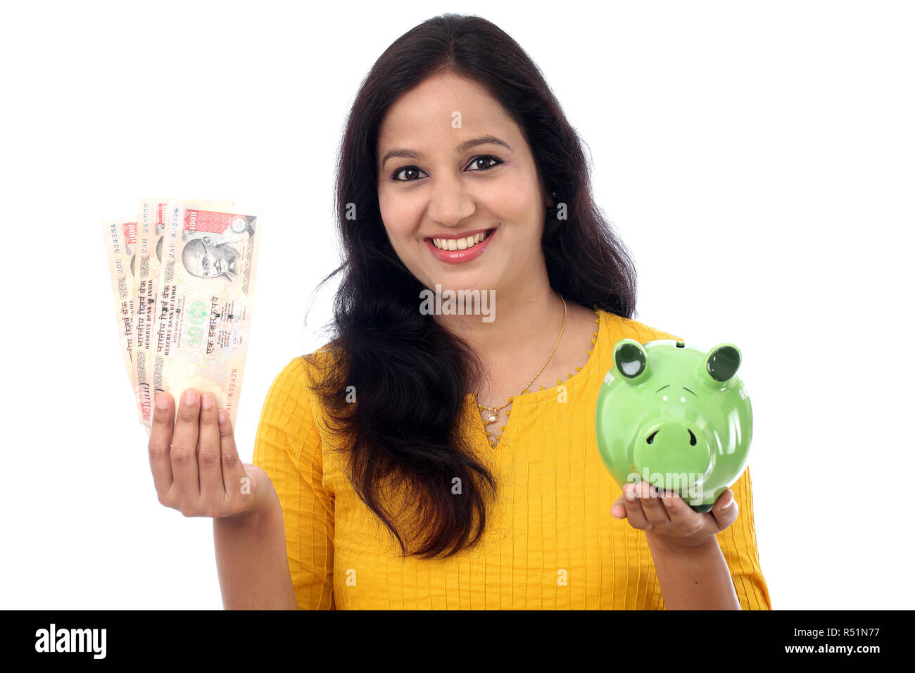 Young Indian Woman Saves Money in Piggy bank Stock Photo - Alamy