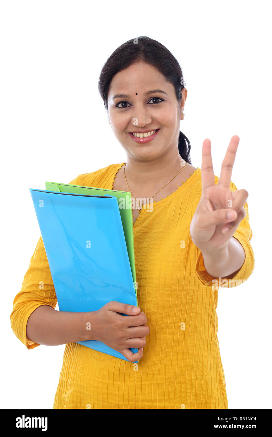 Happy female student with victory gesture Stock Photo Alamy