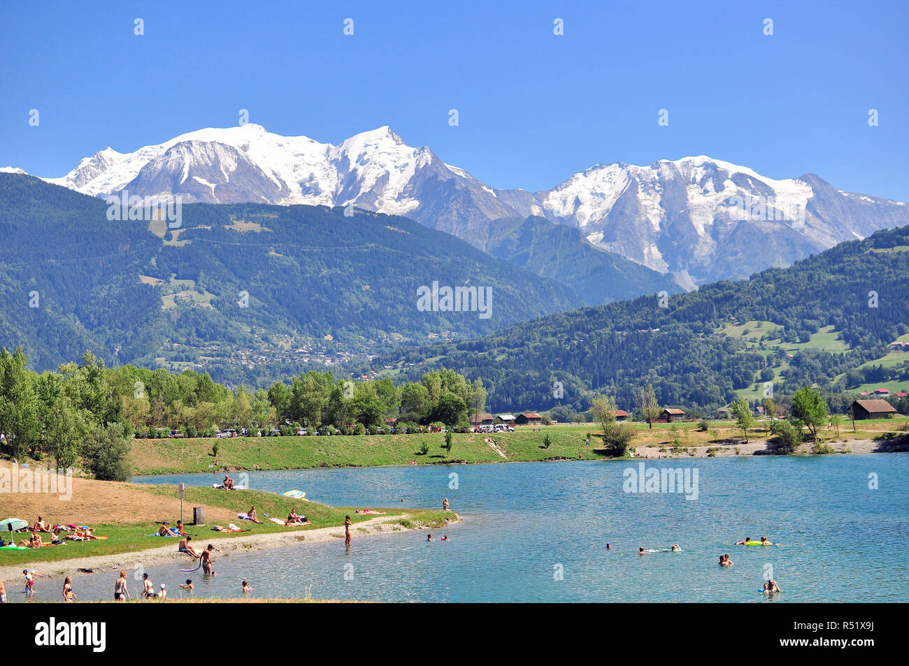 PASSY, FRANCE - AUGUST 13: People swimming in Passy lake, french Alps on August 13, 2015. Stock Photo