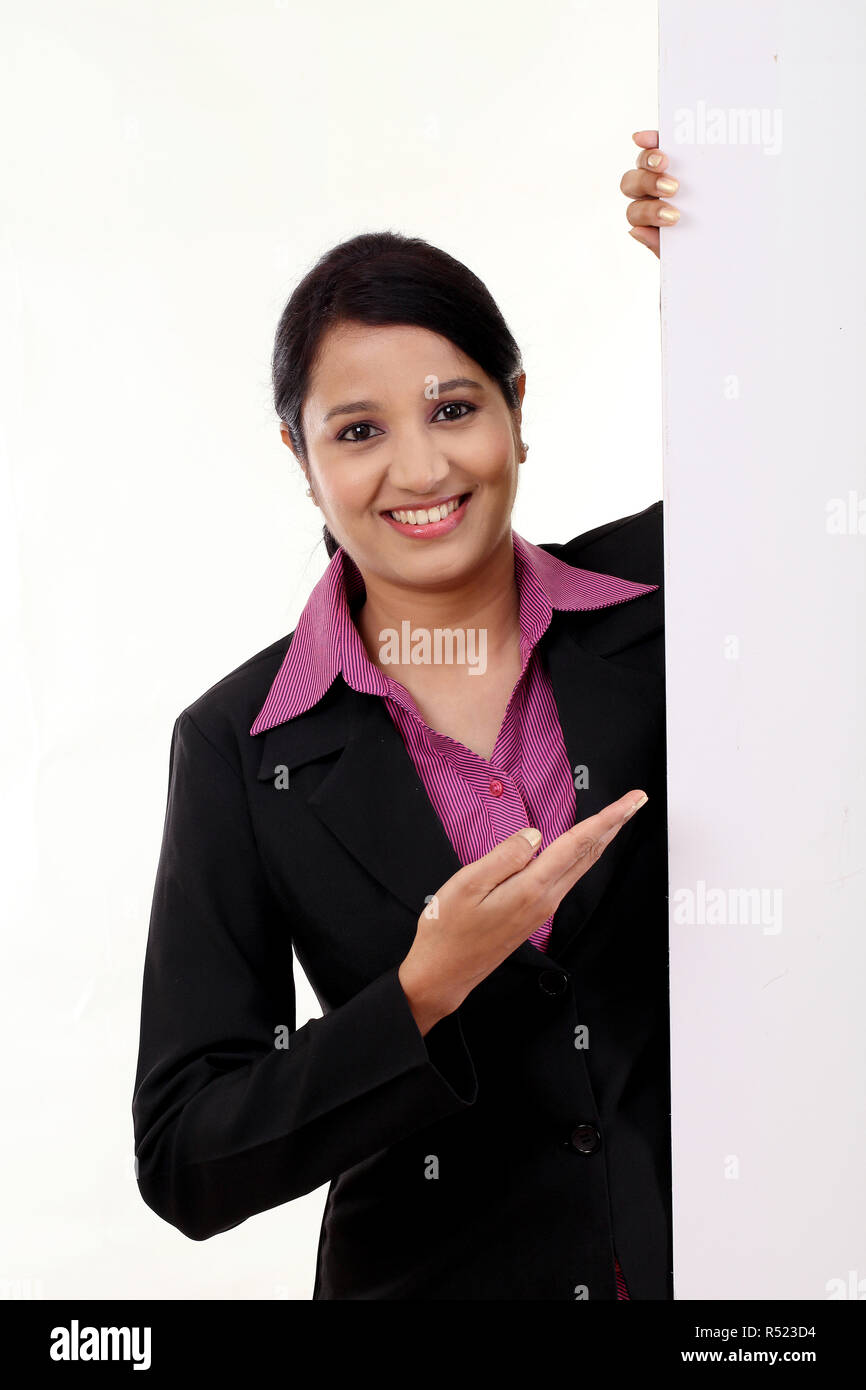 Happy business woman showing blank signboard against white Stock Photo ...