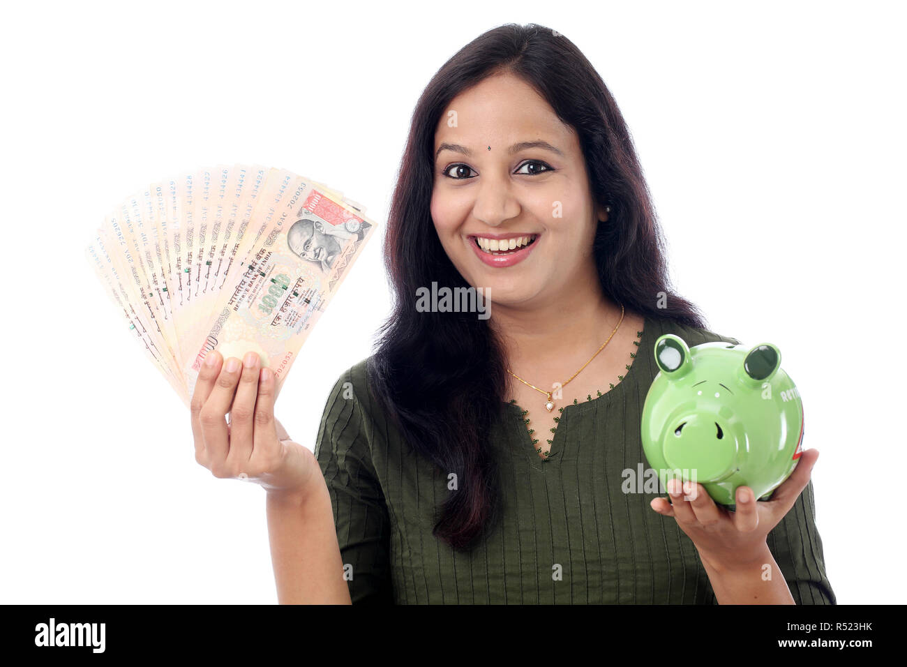 Young Indian Woman Saves Money in Piggy bank Stock Photo - Alamy