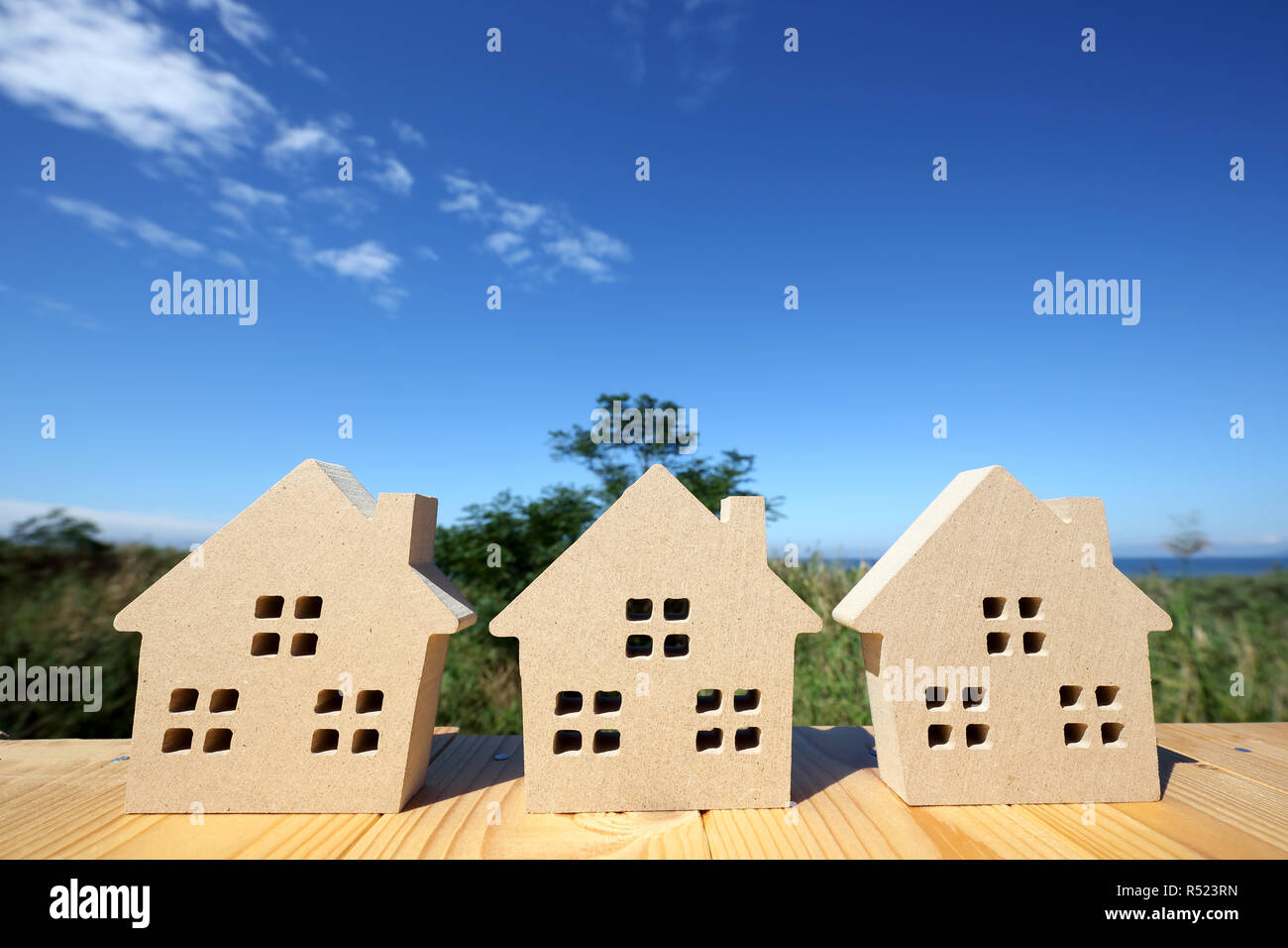 Miniature model of house with blue sky background Stock Photo - Alamy