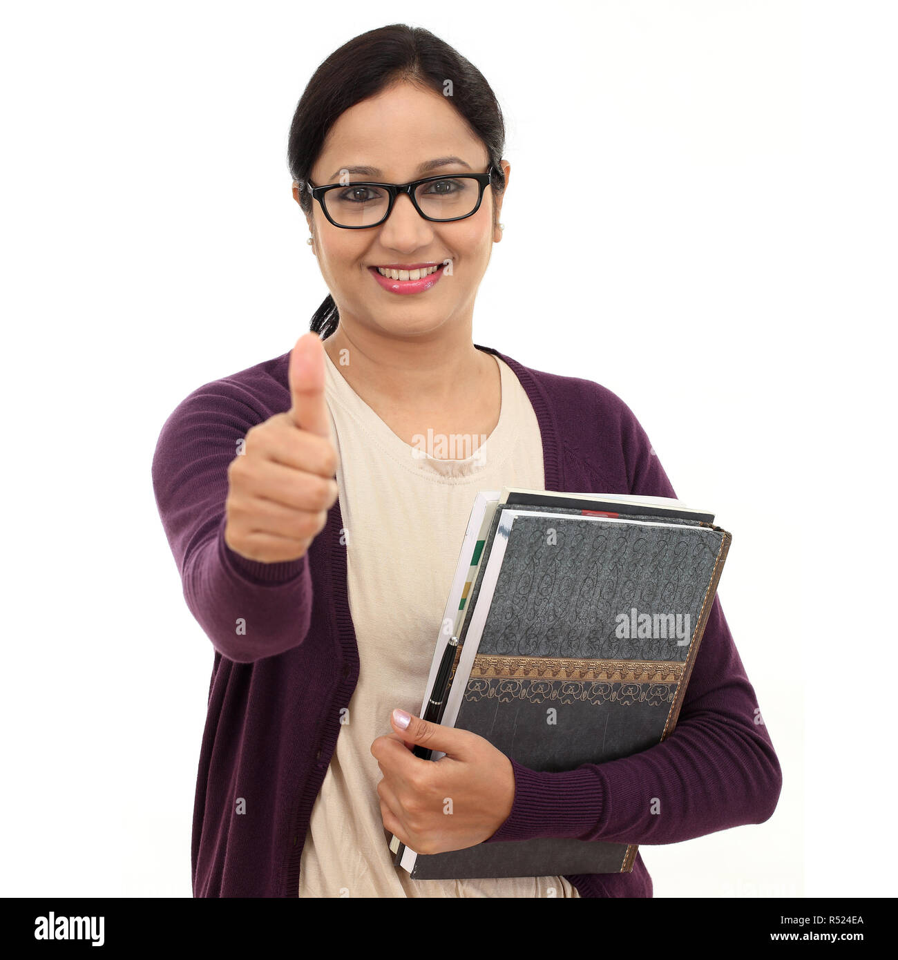 Young female student with thumbs up gesture Stock Photo - Alamy