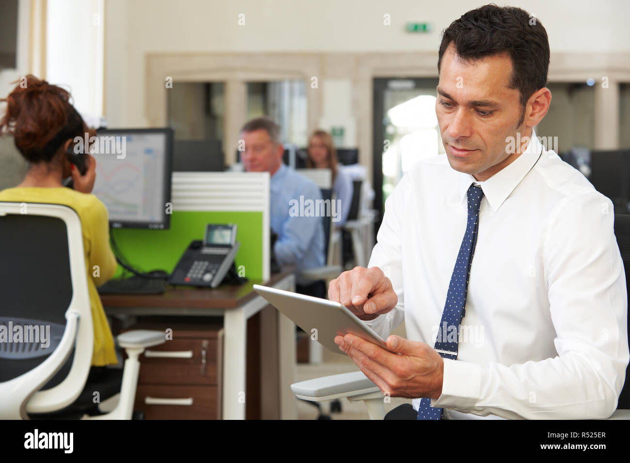 Businessman Using Digital Tablet In Modern Office Stock Photo