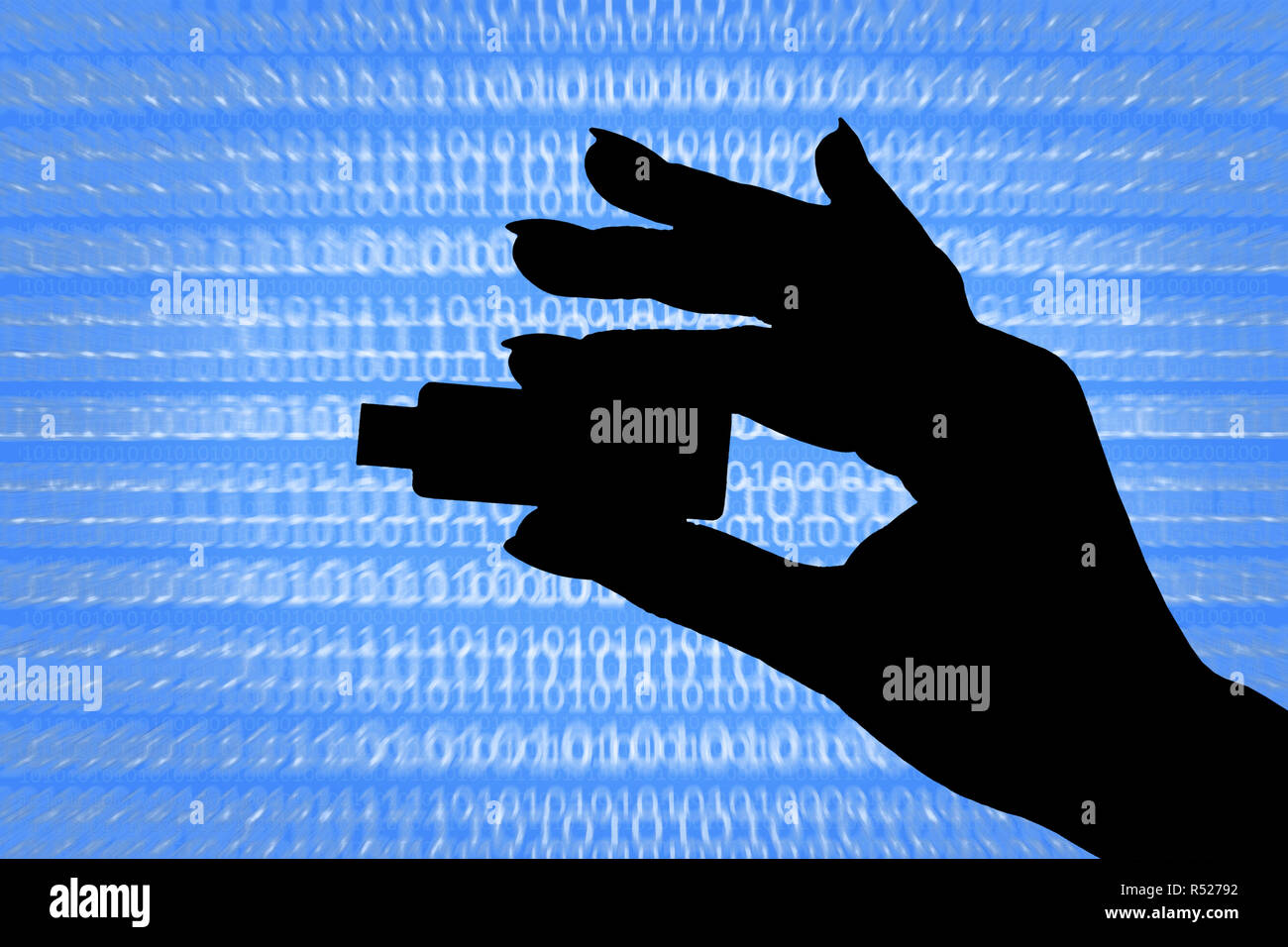 Silhouette of a hand holding a flash drive on an abstract digital background. The concept of data theft, data protection, computer hacking. Stock Photo