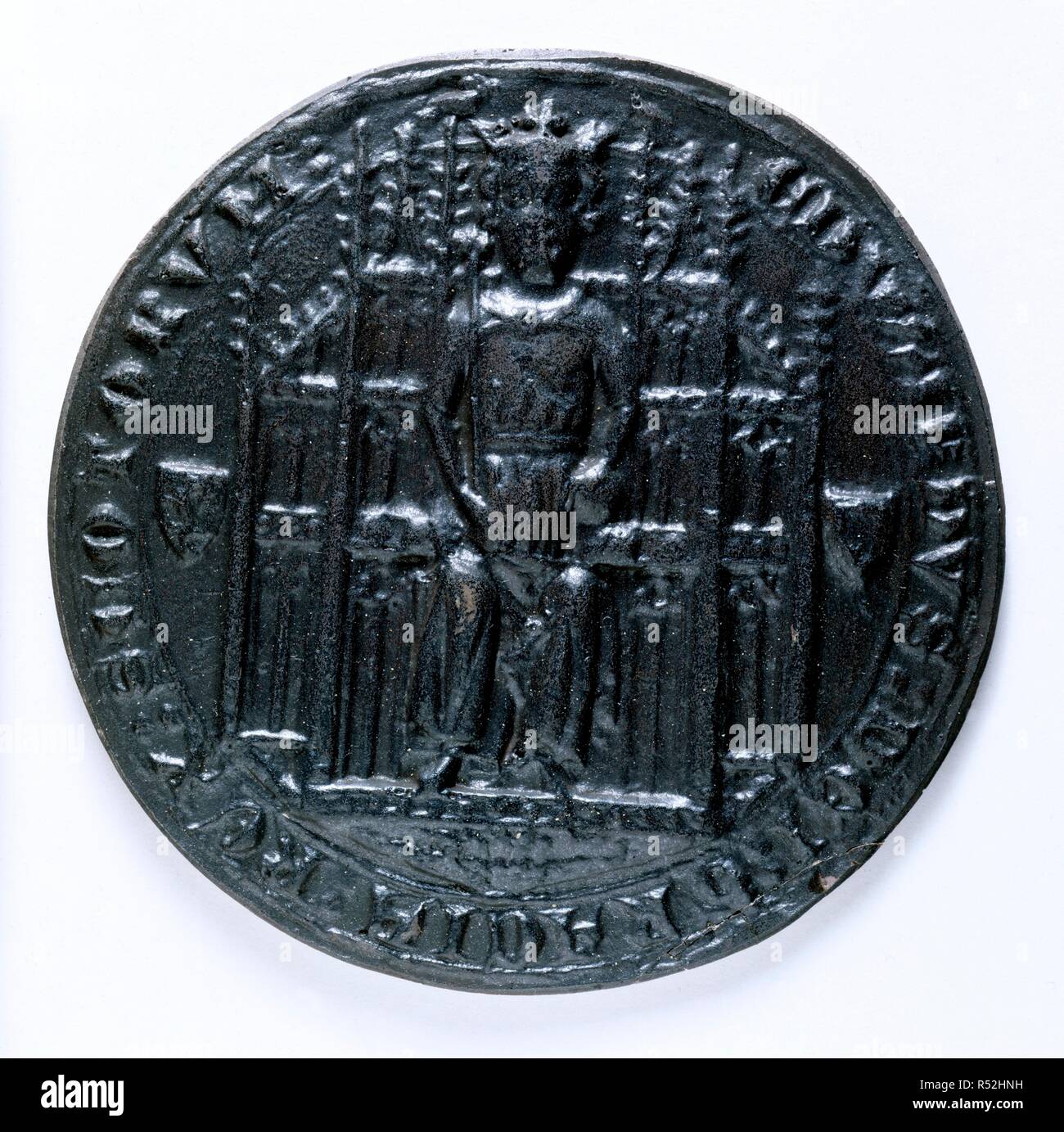 Seal of Edward Balliol. Scotland; circa 1332. [Obverse] Impression of the seal of Edward Balliol, King of the Scots. The king is enthroned, with a crown, and wearing a loose vestment with the mantle fastened across the chest. He holds a sceptre in the right hand, and in the left hand, an orb on a small cushion. The throne is of carved tabernacle work, with crocketted pinnacles; the two nearest the head of the king have doves perched on top, facing each other. Either side of the throne is a heraldic shield, one with a lion rampant, the other, an orle  Originally published/produced in Scotland;  Stock Photo