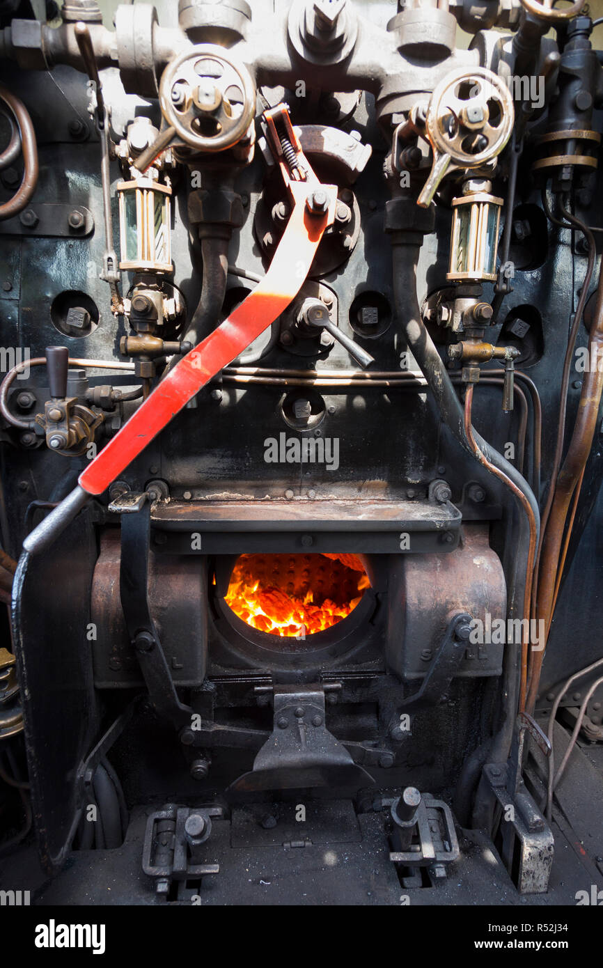 Steam locomotive driver cabin with fire box / firebox & drivers controls / dials & levers in the drivers cab of historic train engine number 41298, running on the Isle of Wight steam Railway line. UK (98) Stock Photo