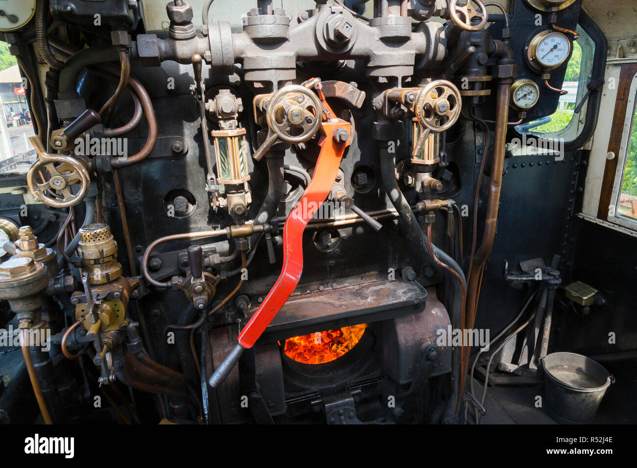 Steam locomotive driver cabin with fire box / firebox & drivers controls / dials & levers in the drivers cab of historic train engine number 41298, running on the Isle of Wight steam Railway line. UK (98) Stock Photo