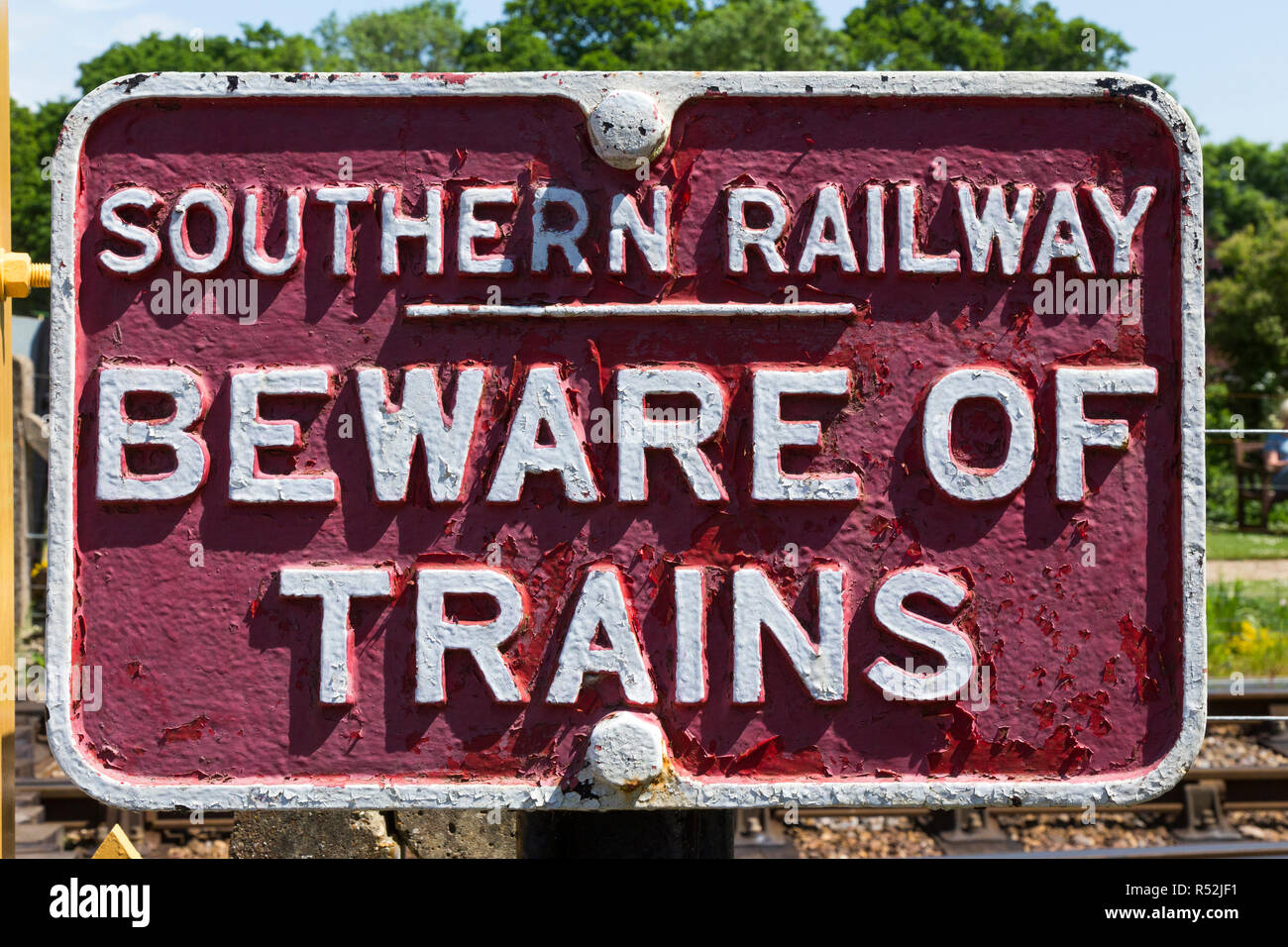 Cast iron painted Beware of the trains sign; vintage / old Southern Railway warning sign that there are moving trains at a crossing. UK (98) Stock Photo