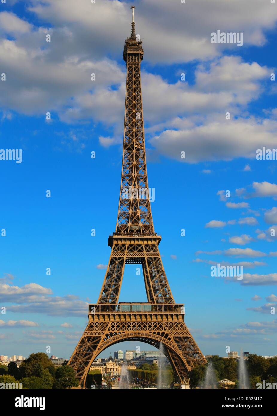 high eiffel tower with very bright colors and white clouds in the blue sky in Paris France Stock Photo