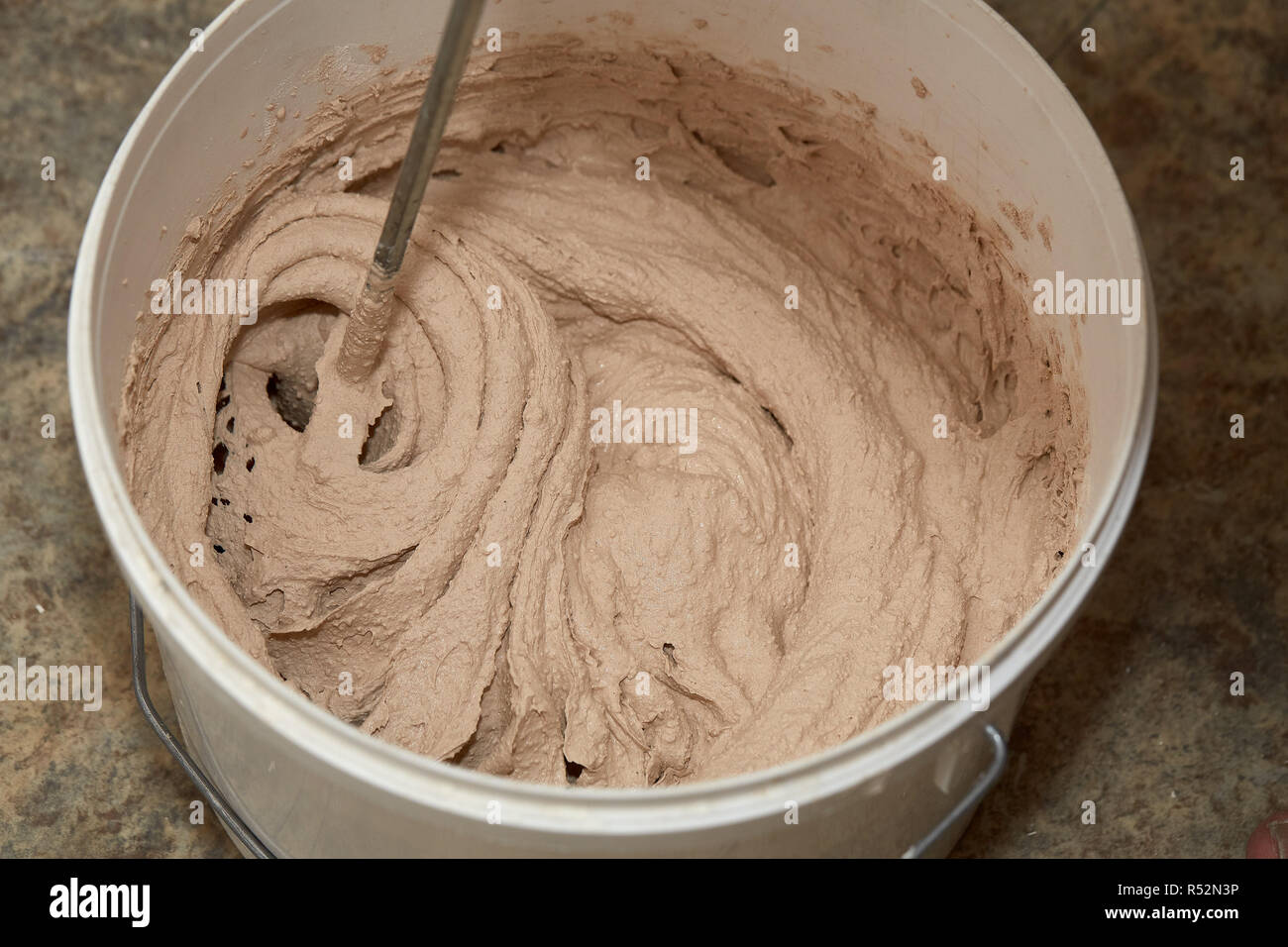 Mixing of a plaster solution by an electric drill Stock Photo Alamy