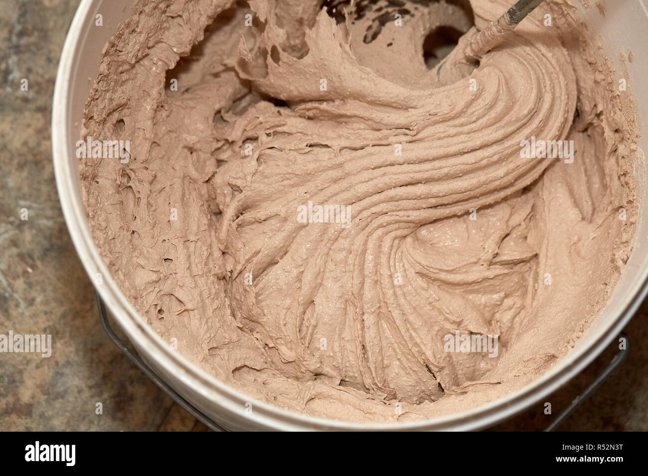 Mixing of a plaster solution by an electric drill Stock Photo Alamy