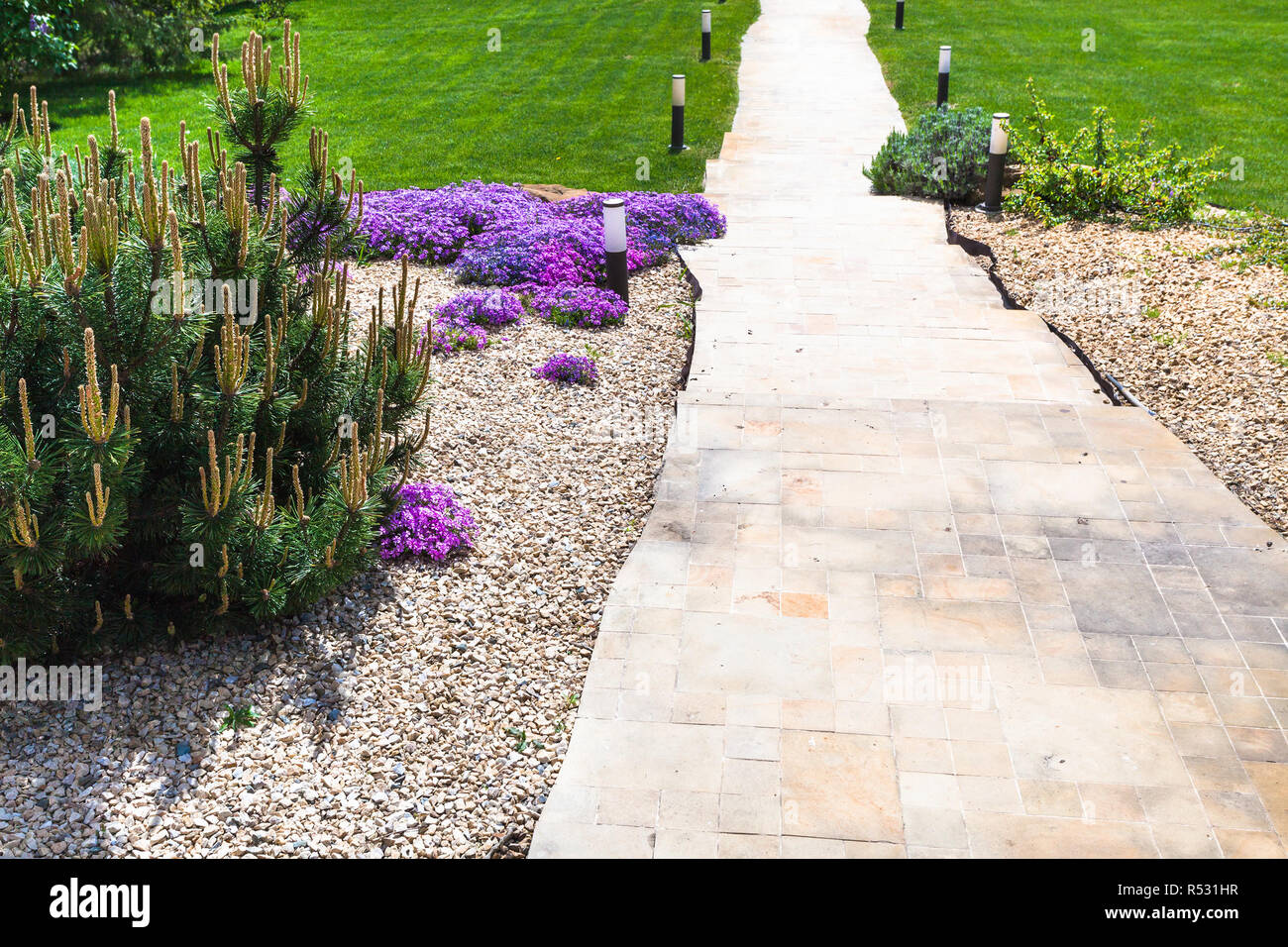 path through alpine garden and sloped lawn Stock Photo Alamy