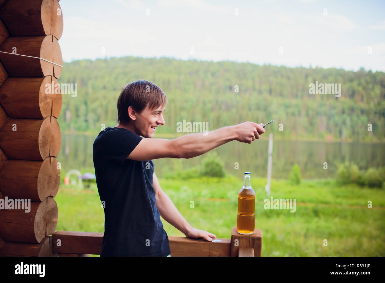Close up man drinking beer from glass at open air near the pool