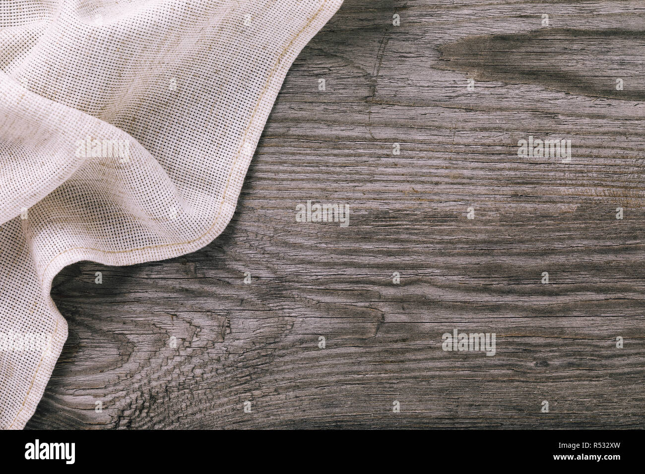 Top view of light tablecloth on left side of wooden table with copy space Stock Photo