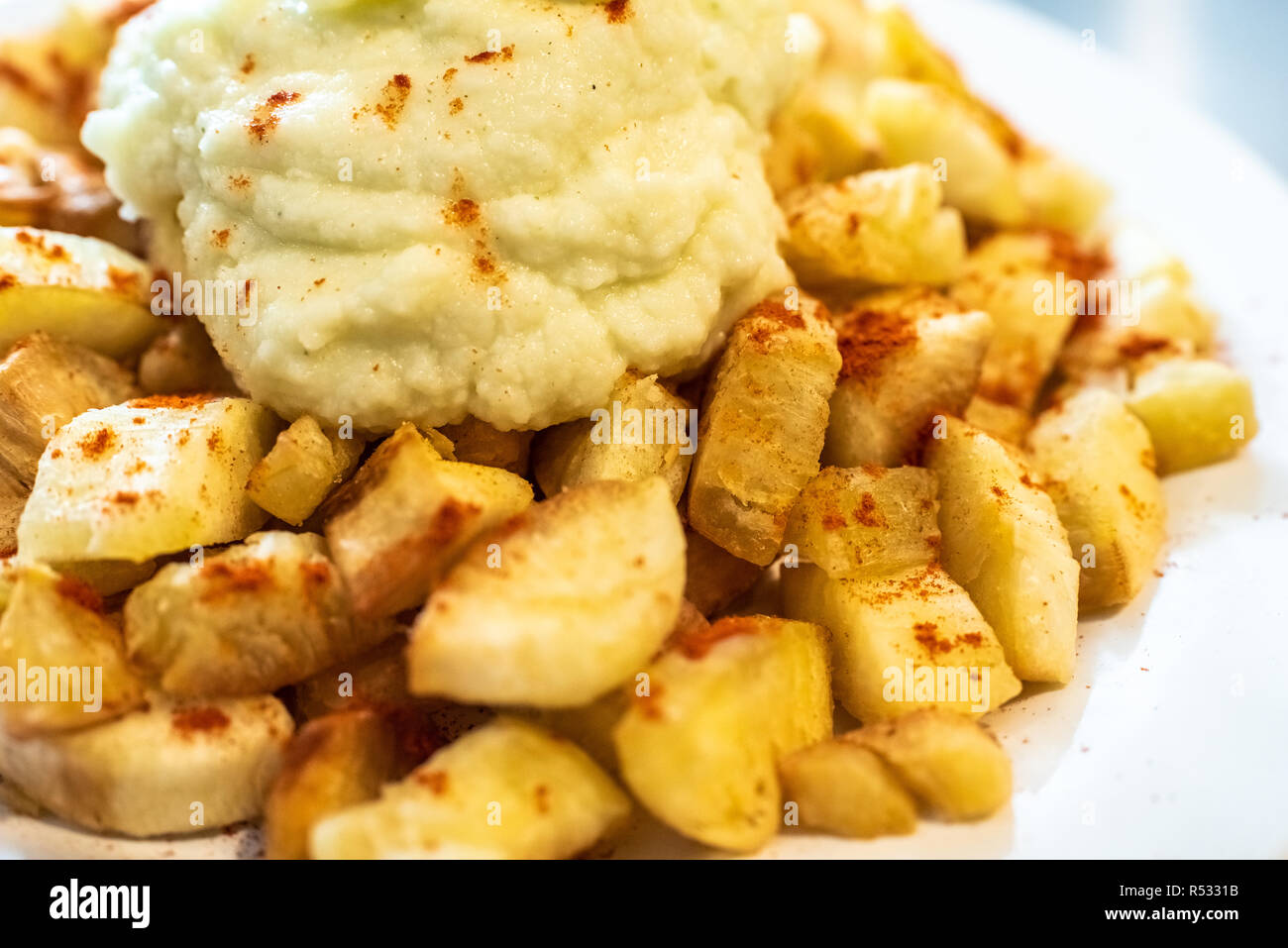 Yuca fried with hummus sauce. Stock Photo