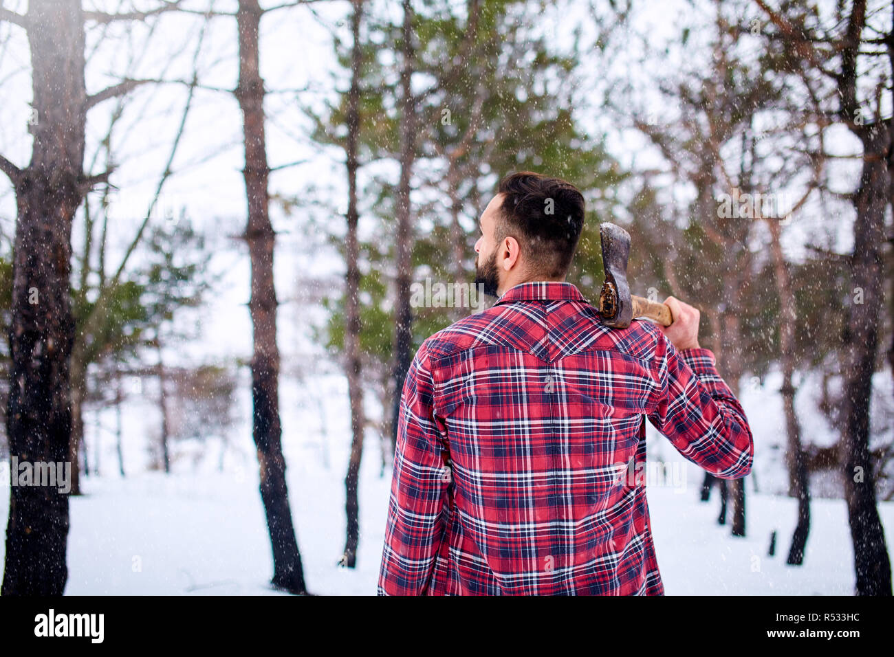 Bearded hipster man in a winter snowy 