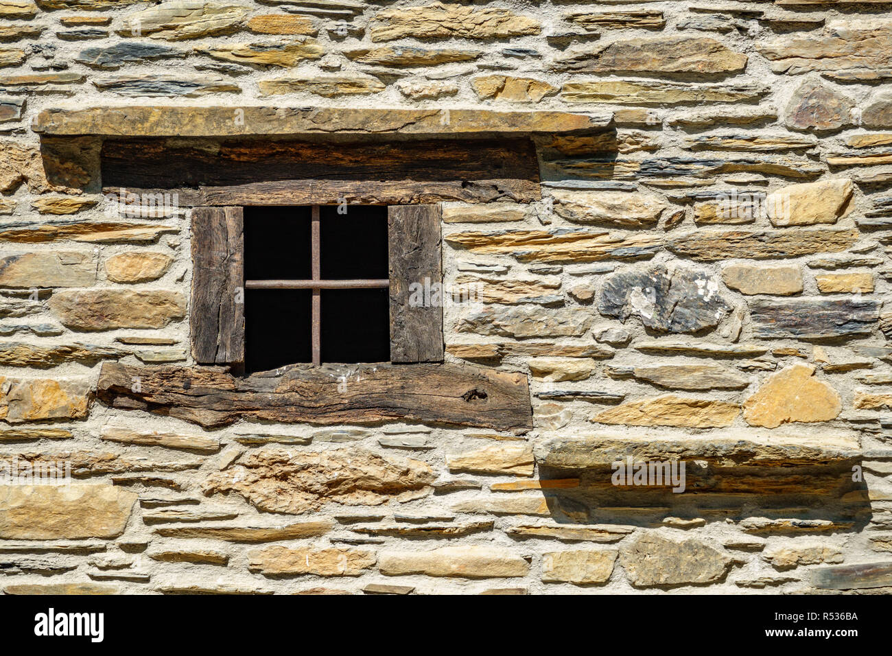 Stone facade with wooden window frame, front view Stock Photo