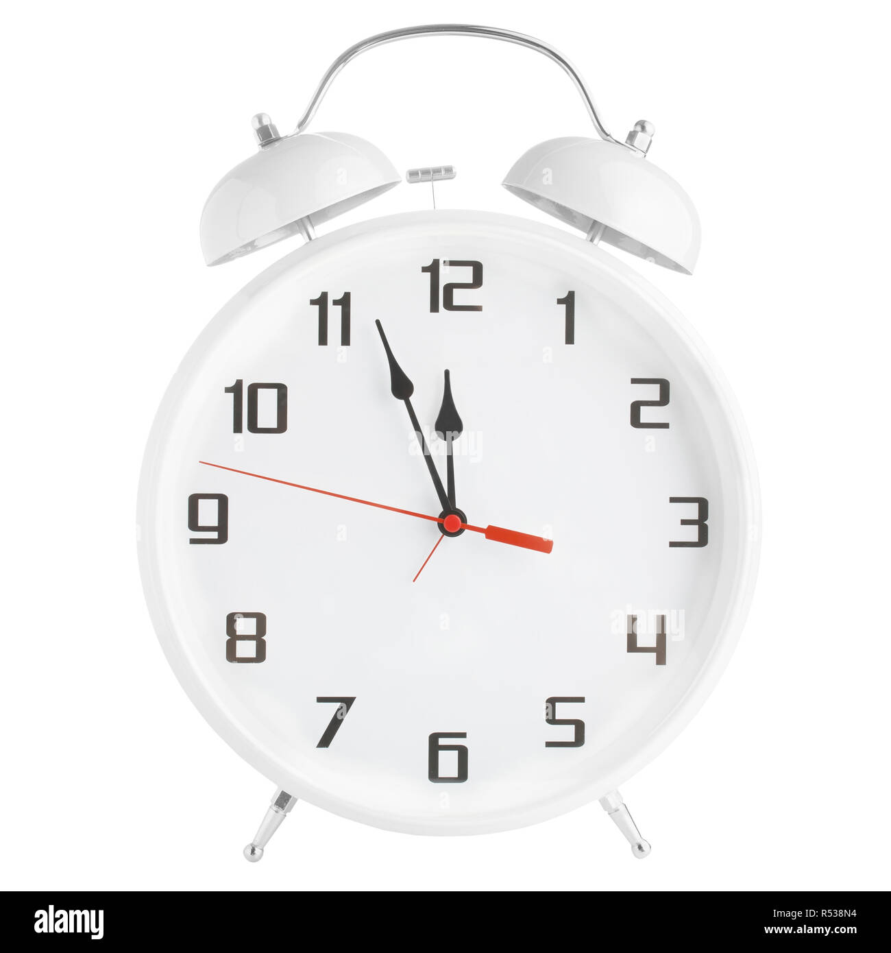 White alarm clock showing twelve o'clock isolated on white background Stock Photo