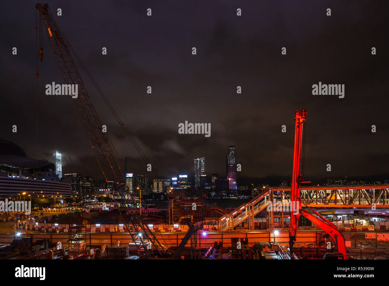 Night view of a construction site along the Victoria harbor near Hong Kong Convention and Exhibition Centre. Hong Kong, Wan Chai, January 2018 Stock Photo