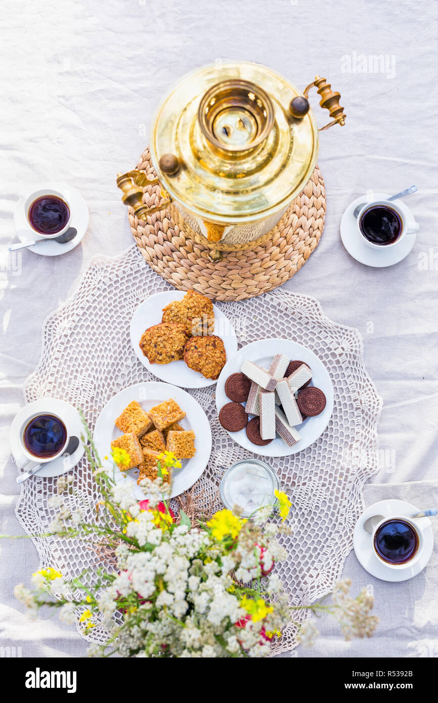 View from above on table with samovar, coffee cups, sweets Stock Photo