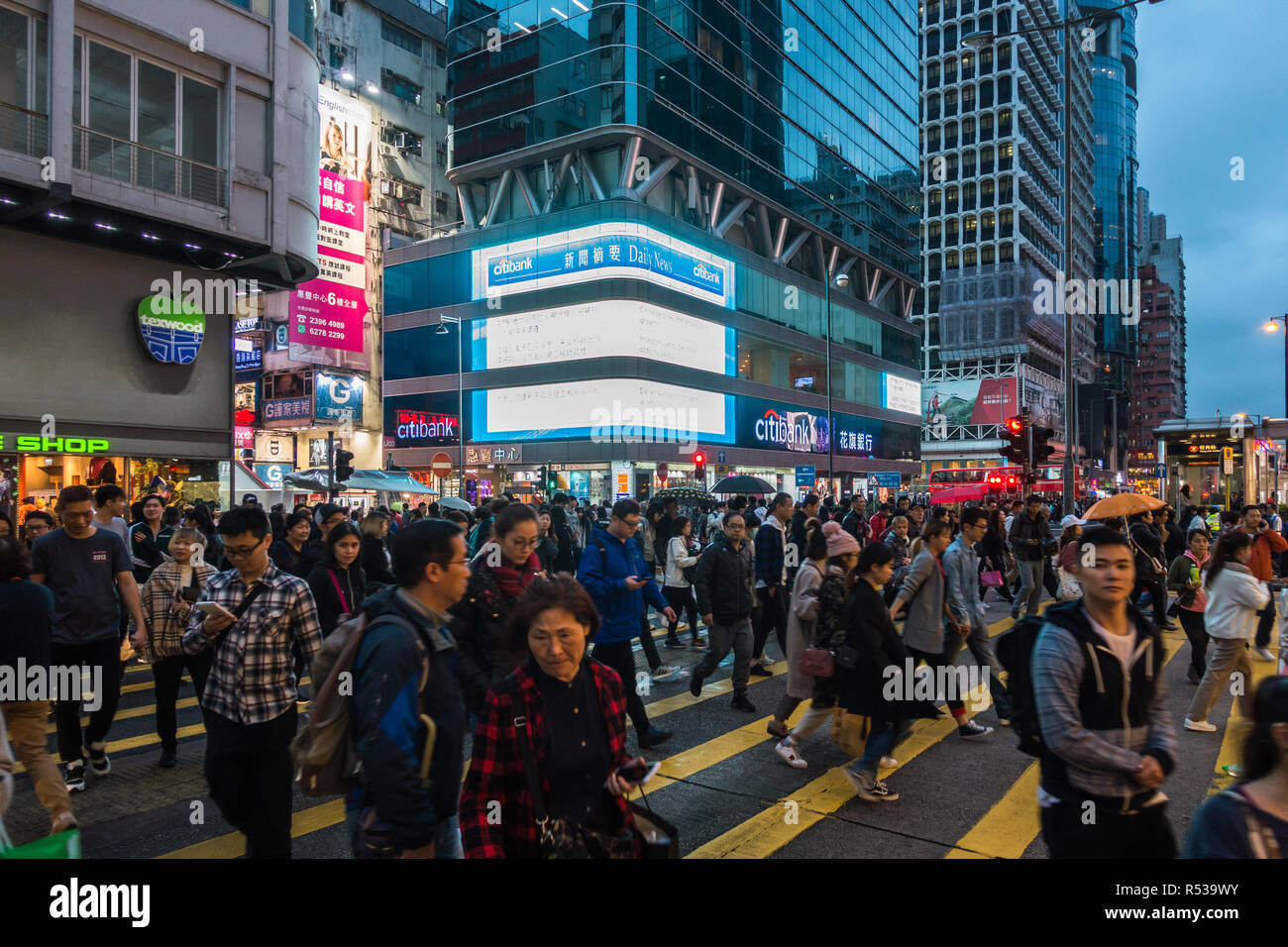 People crossing Nathan Road in Mong Kok, one of most densely populated areas in the world. Hong Kong, Kowloon, January 2018 Stock Photo