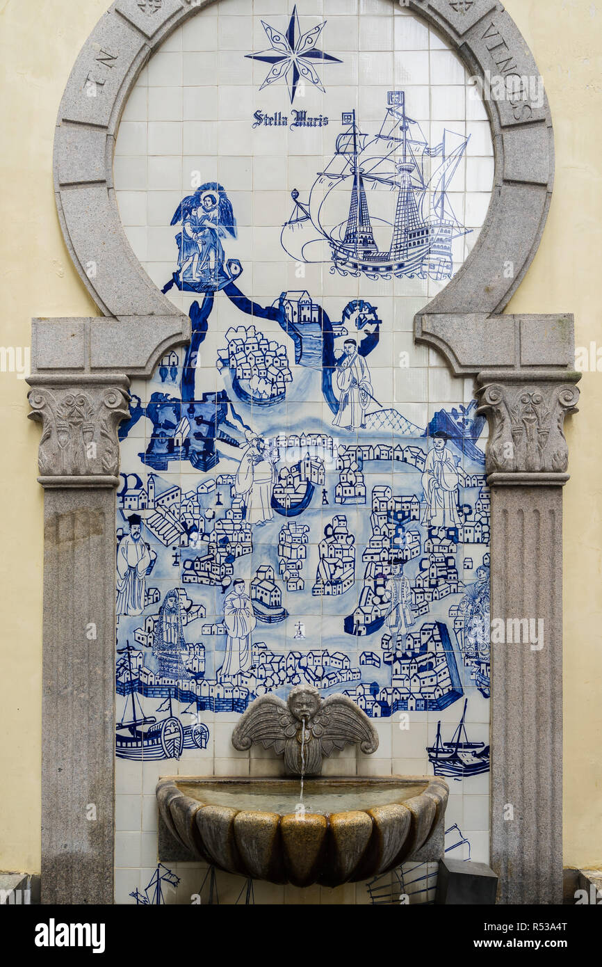 A small fountain in the historic centre of Macau with traditional 18th century blue and white tiles mixing Chinese and European styles Stock Photo