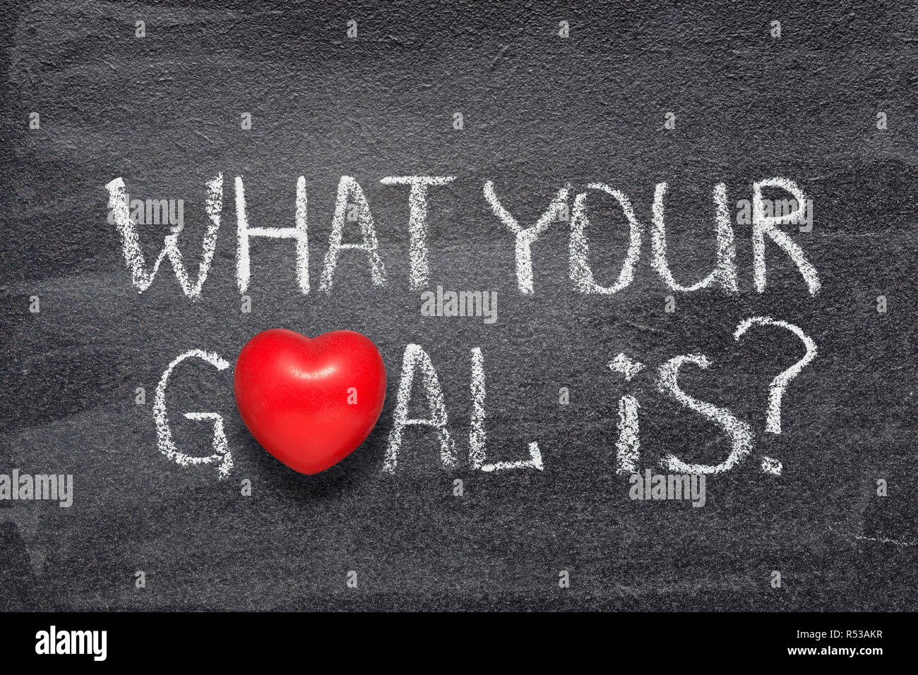 what your goal is question handwritten on chalkboard with red heart symbol instead of O Stock Photo