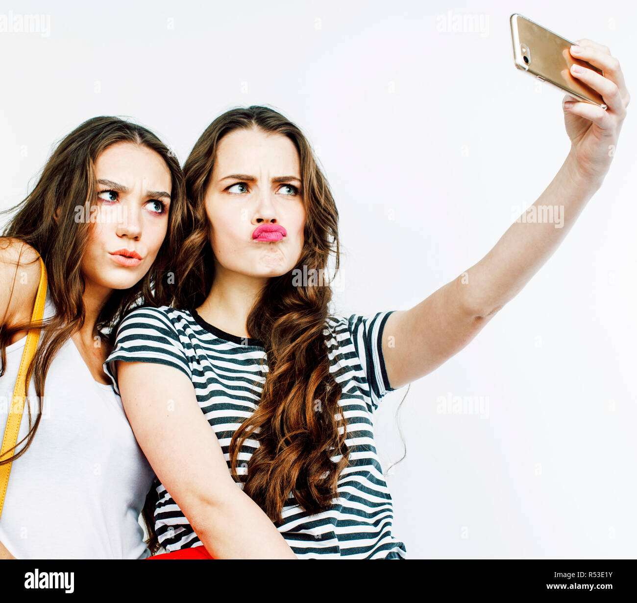 two best friends teenage girls together having fun posing emotional on white background besties happy smiling making selfie lifestyle people conce R53E1Y