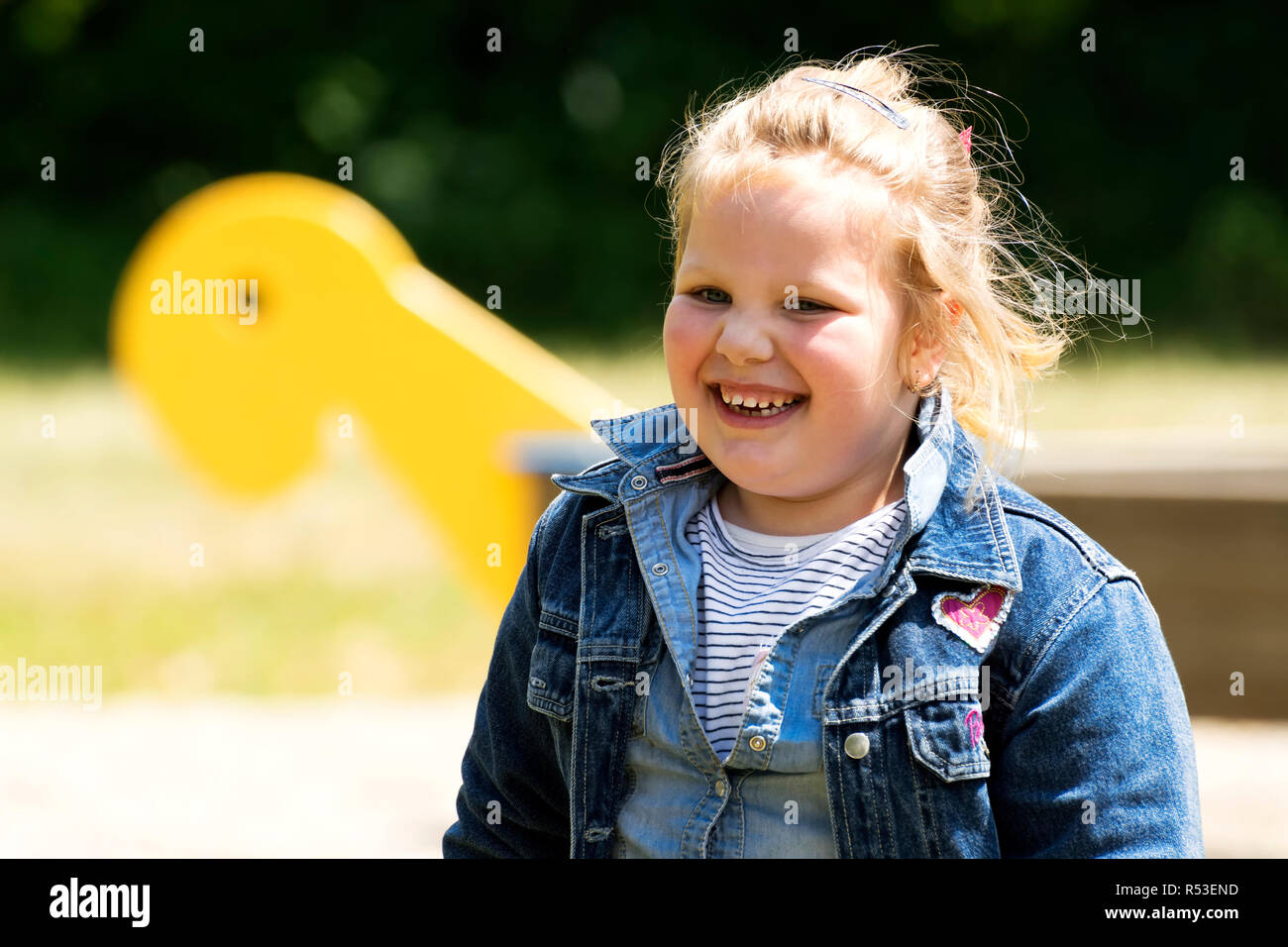 Happy little girl at playground Stock Photo - Alamy