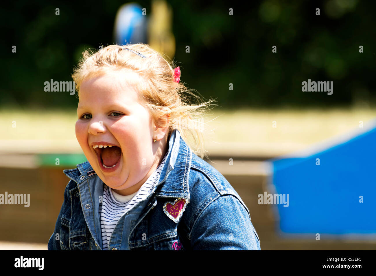 Happy little girl at playground Stock Photo - Alamy