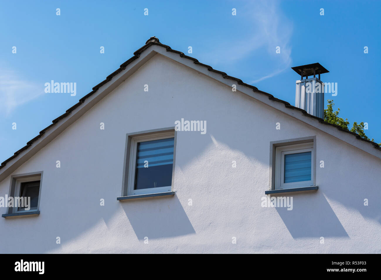 house facade in front of blue sky. Stock Photo