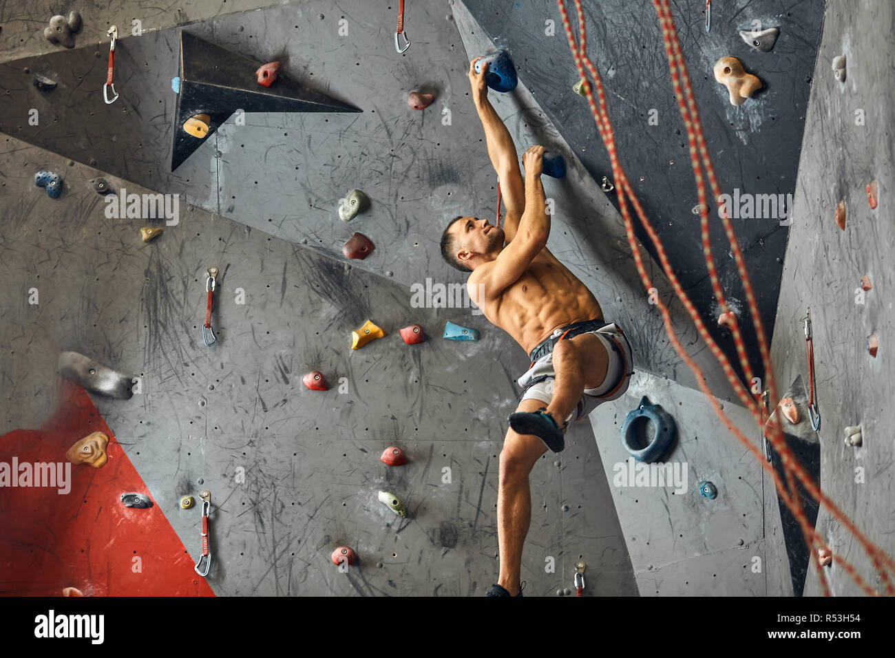 Panoramic man bouldering at an indoor climbing centre Stock Photo Alamy