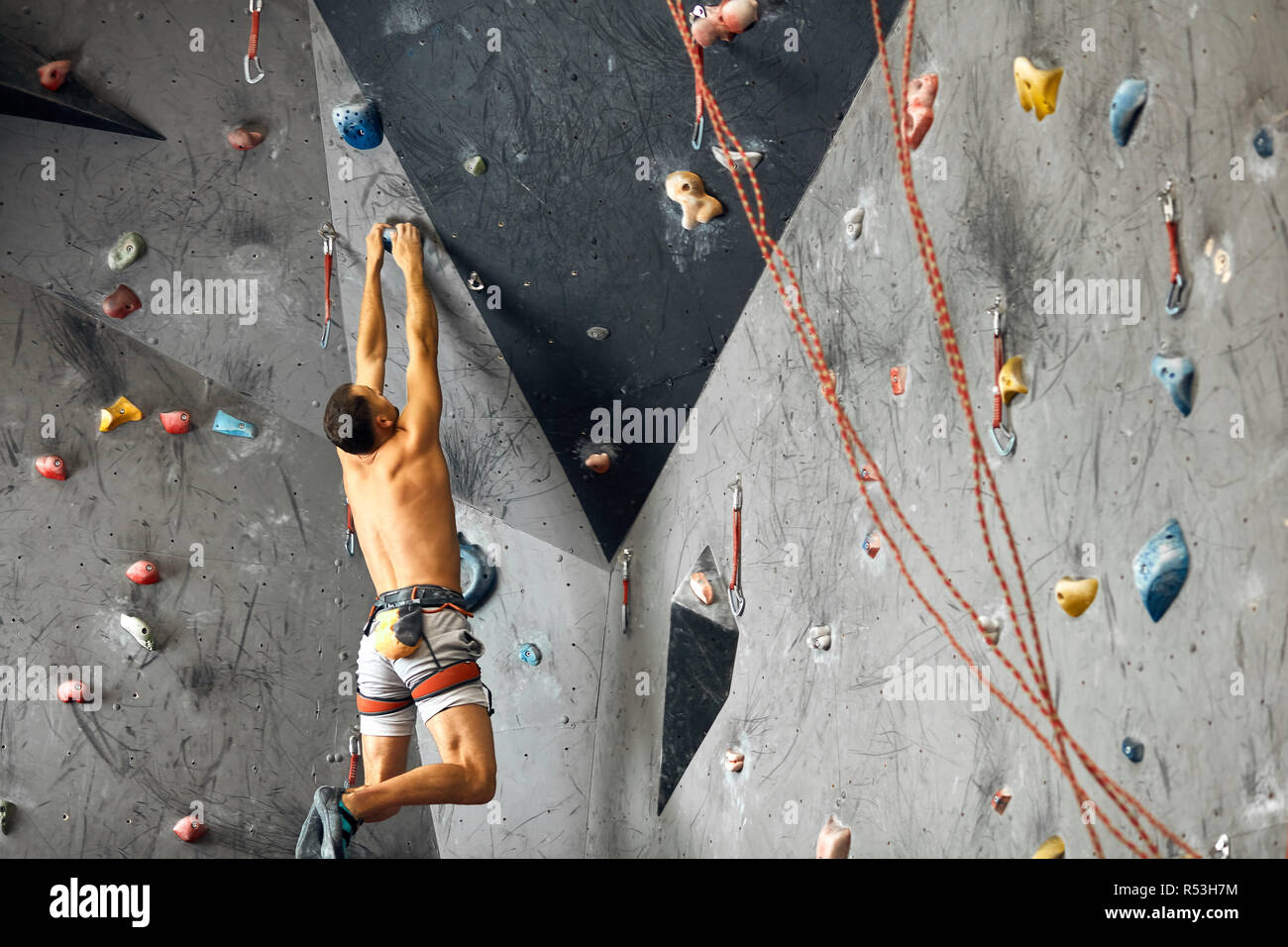 Panoramic man bouldering at an indoor climbing centre Stock Photo Alamy