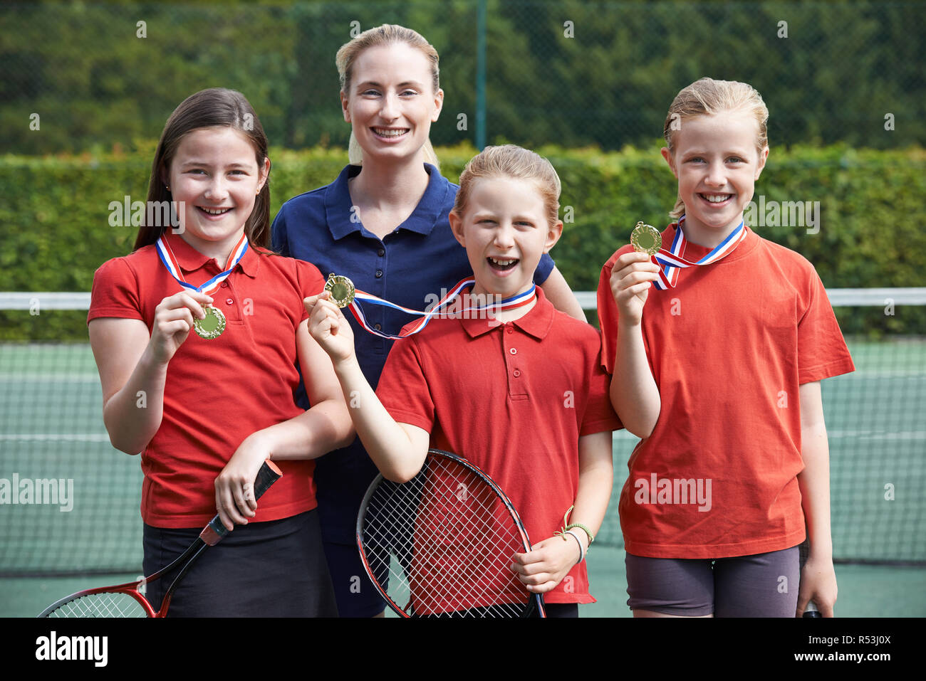 Portrait Of Winning Female School Tennis Team With Medals Stock Photo Alamy