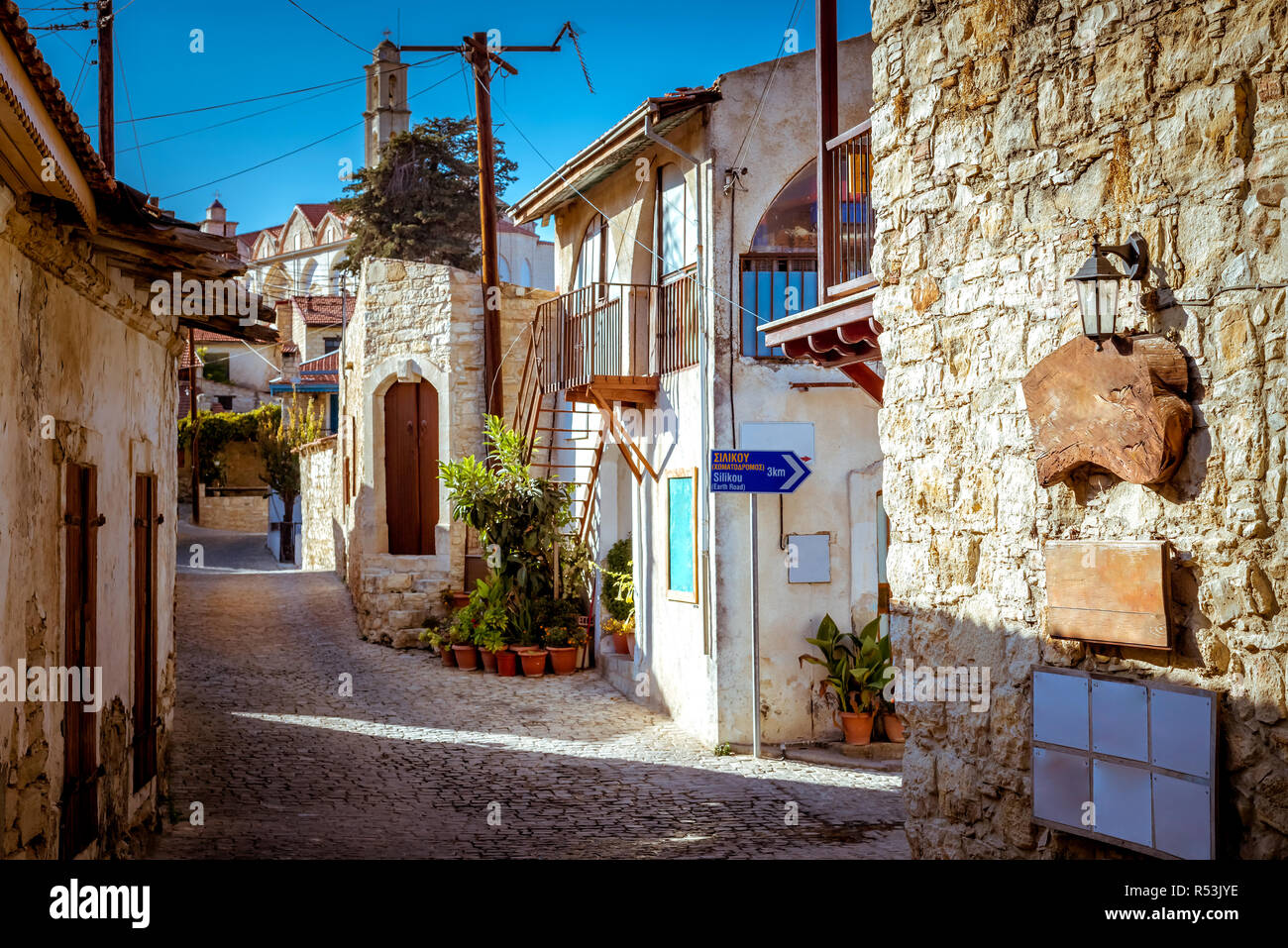 Old stone houses on a narrow street in the picturesque medieval city of Lofou. Limassol District, Cyprus. Stock Photo