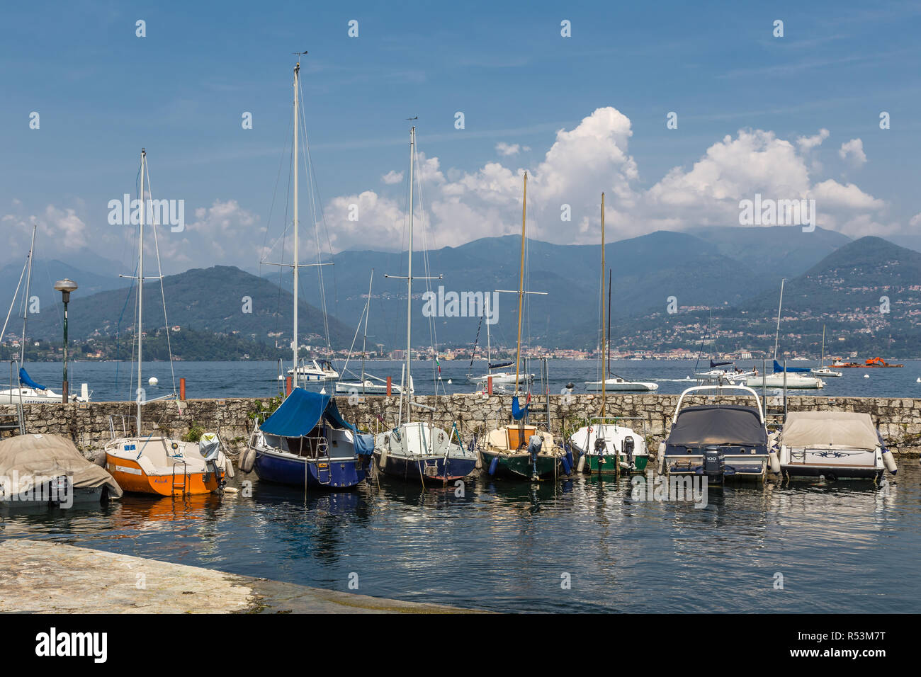 Cerro, Lombardy, Italy, July 15, 2013: Yachts in the marina on Lake Maggiore, with mountains in the background. Stock Photo