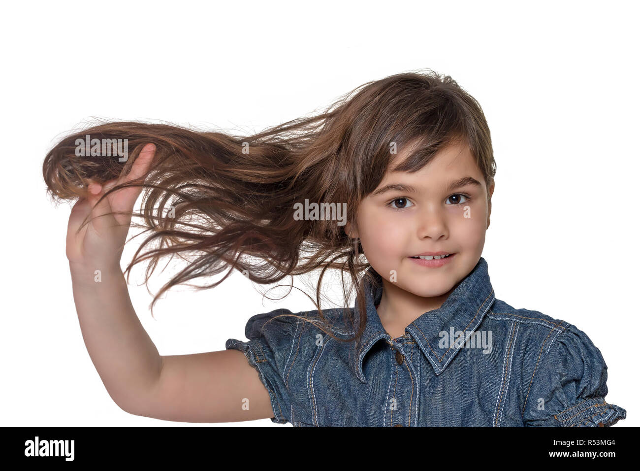 Portrait of little girl holding her hair isolated Stock Photo - Alamy