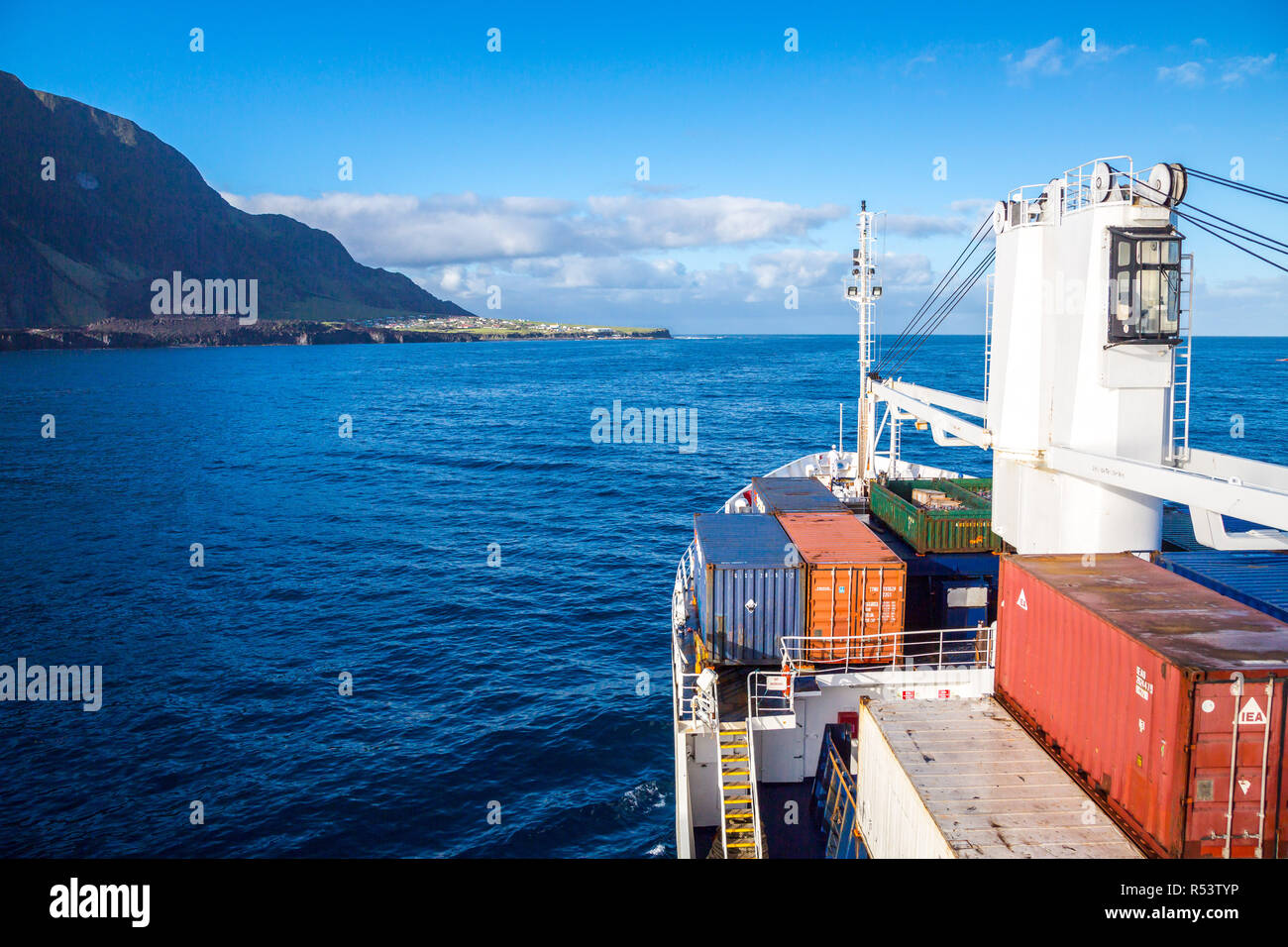 A cargo ship is arriving to Edinburgh of the Seven Seas, the main and only town (settlement) of Tristan da Cunha island, British overseas territory. Stock Photo