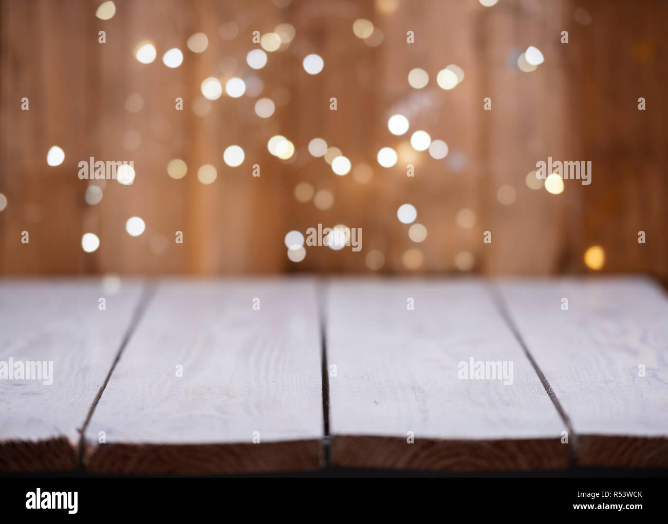 Christmas Bokeh background with empty wooden Stock Photo