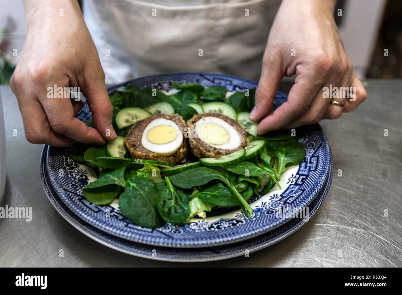 Scotch Egg with Spinach and Cucumber Salad Stock Photo