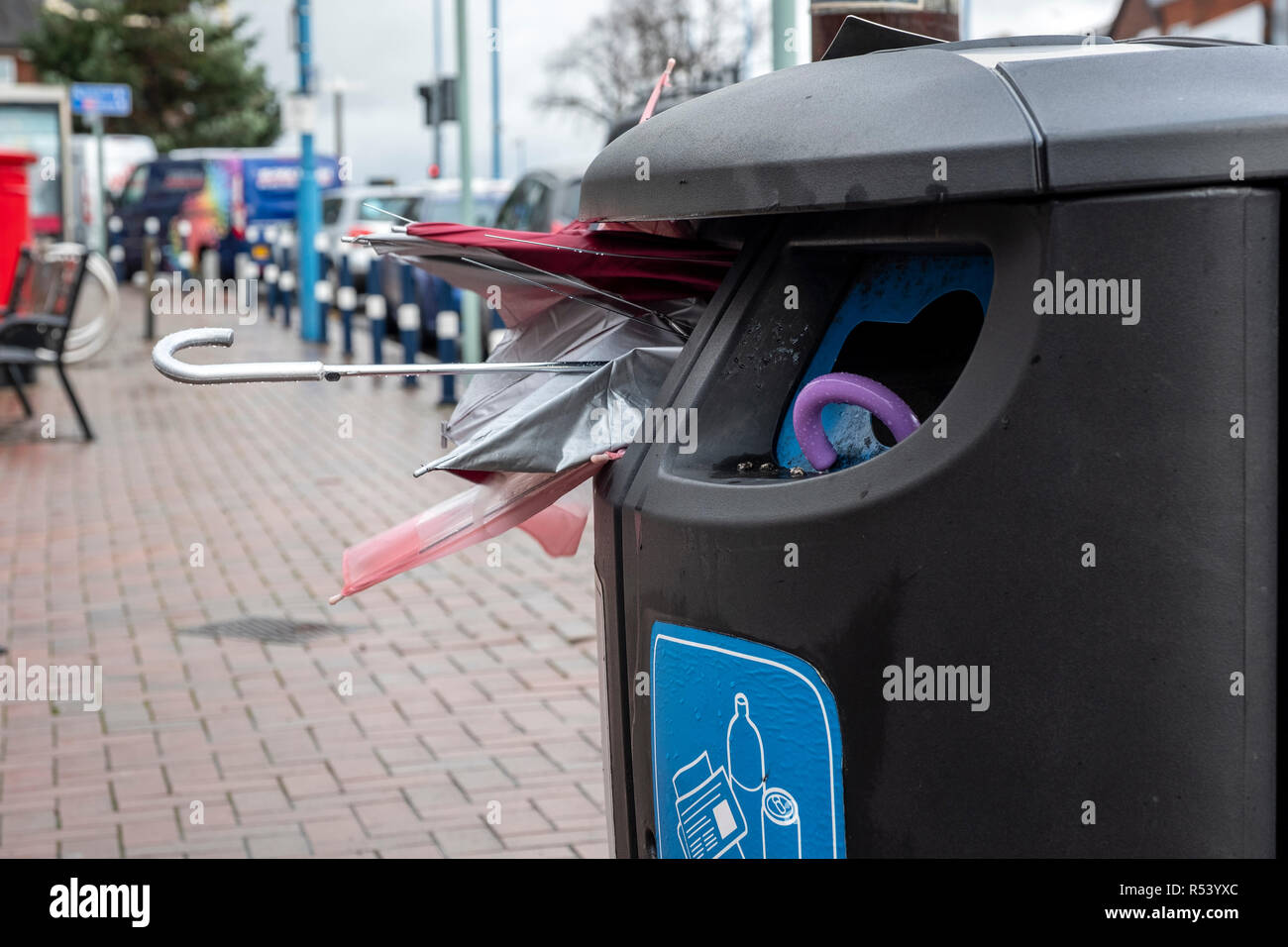 Broken umbrellas pushed in recycling bins after being broken in storms and high winds, West Bromwich, UK Stock Photo
