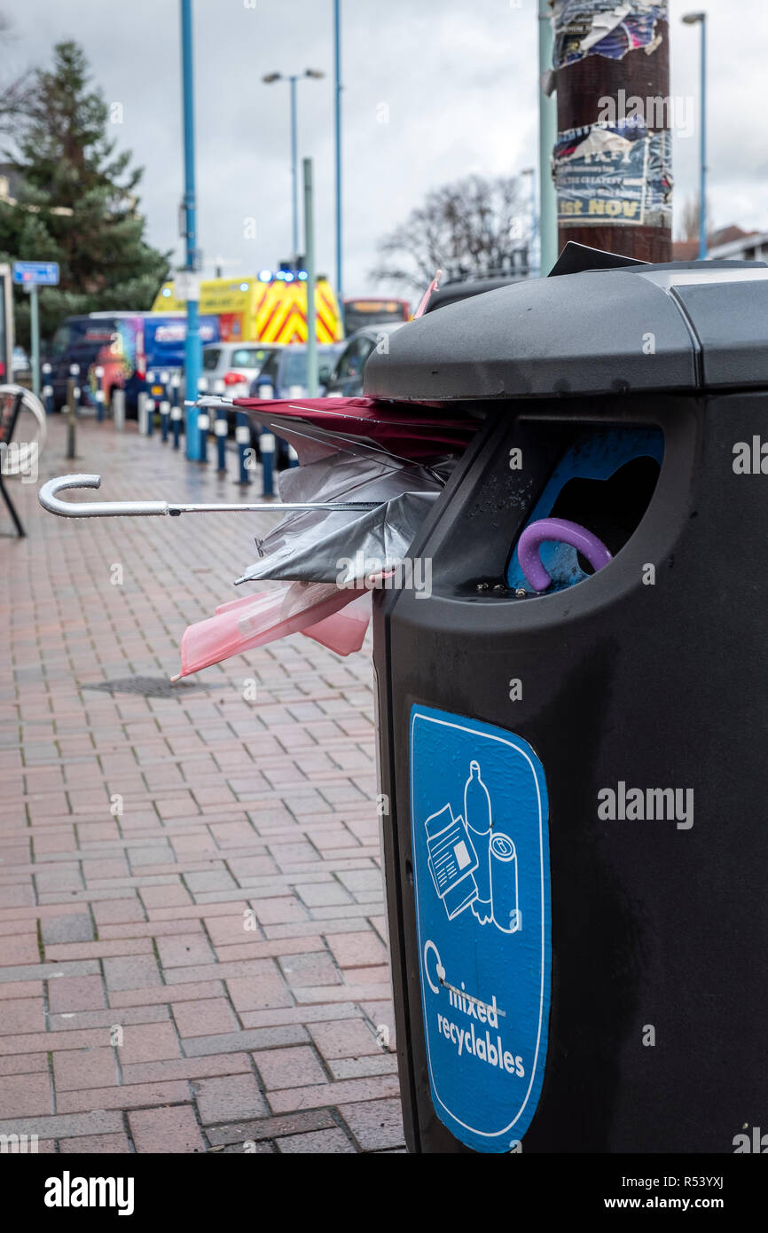 Broken umbrellas pushed in recycling bins after being broken in storms and high winds, West Bromwich, UK Stock Photo