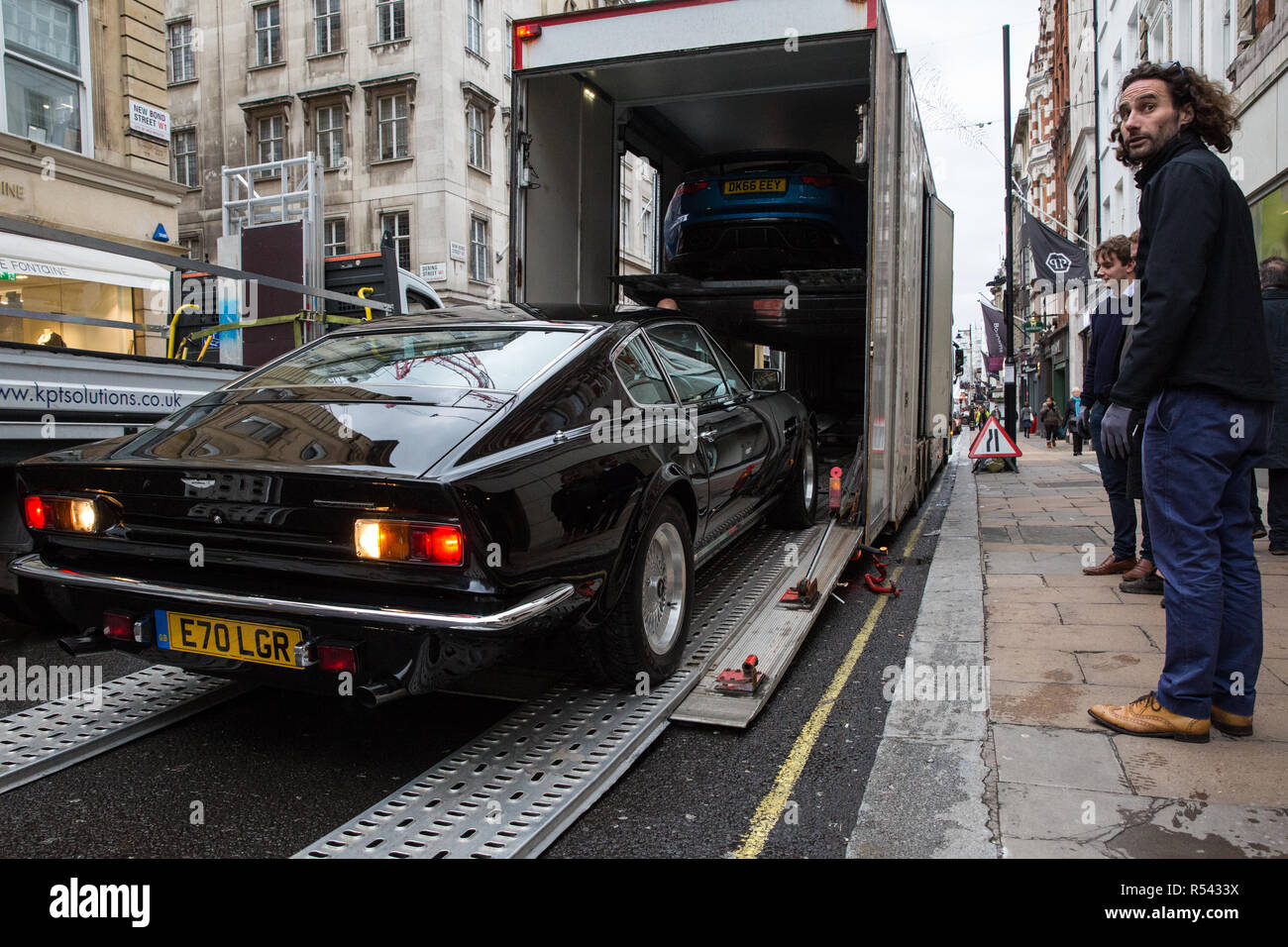 London, UK. 29th November, 2018. Bonhams' staff move a 1988 Aston Martin V8 Vantage X-Pack Sports Saloon, one of only around 130 built, in preparation for an auction of historic and high-performance racing and road cars. Highlights include a Le Mans class-winning Jaguar XJ220C driven by David Coulthard (£2,200,000-2,800,000), a Lister Jaguar Knobbly (£2,200,000-2,800,000) and a 1958 BMW 507 owned by its designer, as well as Ferraris, Aston Martins, Bentleys, Porsches and Jaguars. Credit: Mark Kerrison/Alamy Live News Stock Photo
