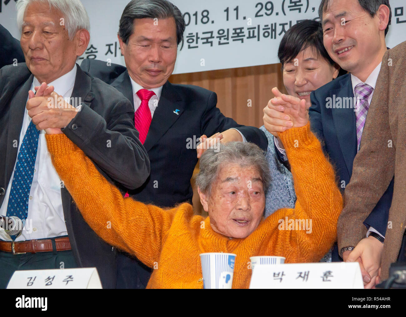 Kim Sung-Joo and Makoto Takahashi, Nov 29, 2018 : Kim Sung-Joo (C), a victim of Japan's forced labor during World War II and Japanese lawyer Makoto Takahashi (L) celebrate with South Korean lawyers during a press conference at the Seoul Bar Association near the Supreme Court in Seoul, South Korea after the Supreme Court's ruling on damages suits. According to local media, South Korea's Supreme Court ordered Mitsubishi Heavy Industries to compensate 10 Koreans who worked at its shipyard and other production facilities in Hiroshima and Nagoya in 1944 with no pay and a bereaved family member of a Stock Photo