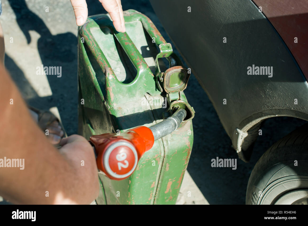 man at a gas station fills the fuel in the vehicle tank Stock Photo - Alamy