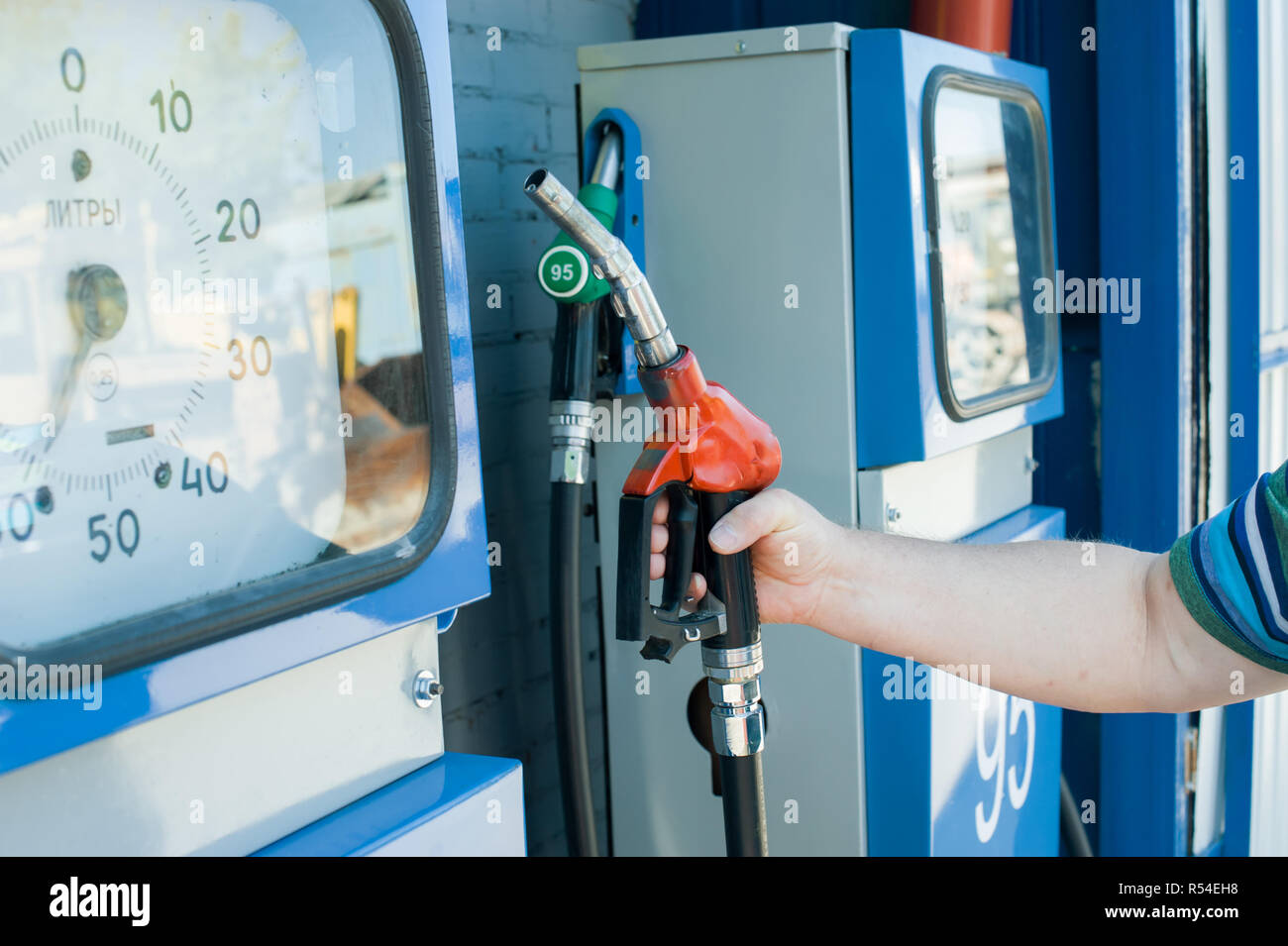man at a gas station fills the fuel in the vehicle tank Stock Photo - Alamy