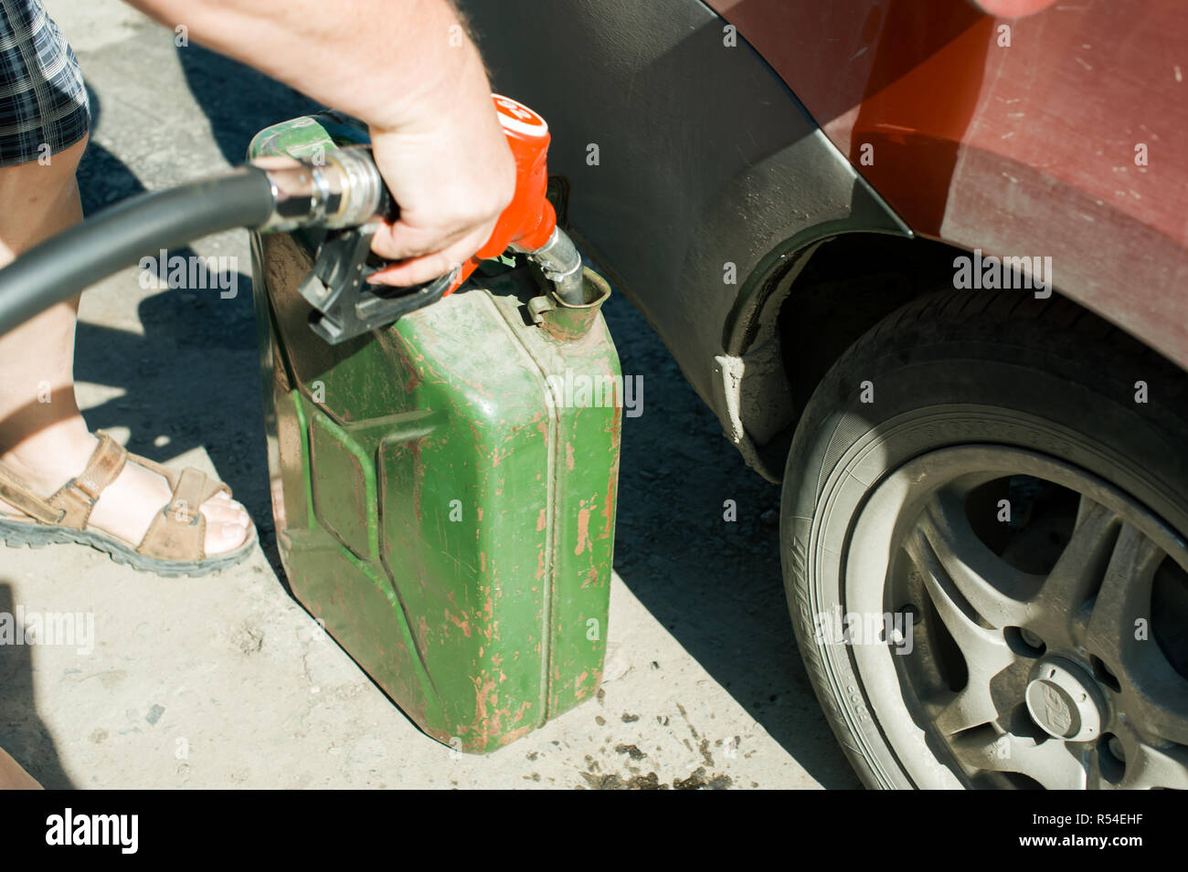 man at a gas station fills the fuel in the vehicle tank Stock Photo - Alamy