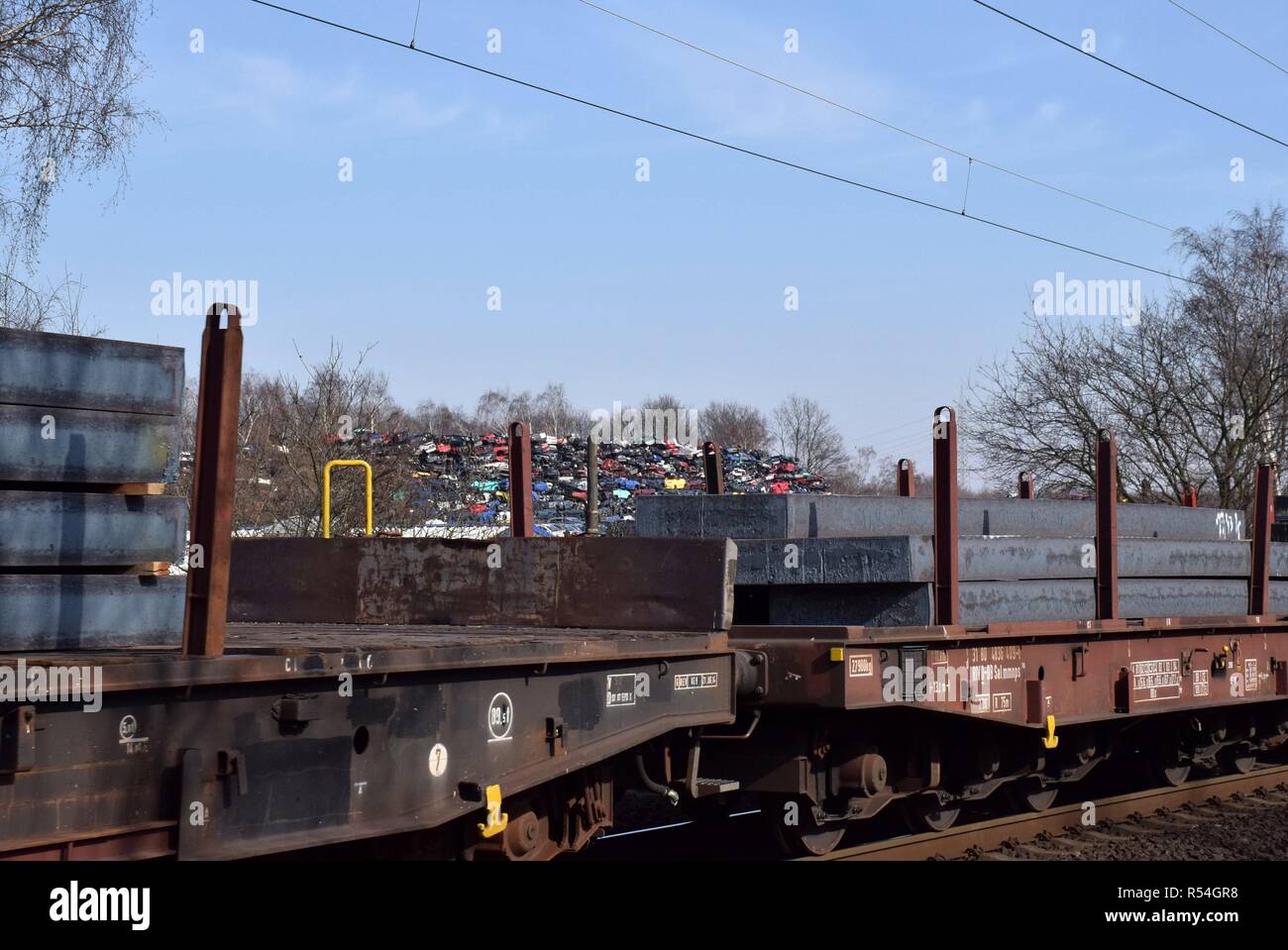 Steel slabs on a freight train and junk cars on 01.03.2018 in Bottrop - Germany. | usage worldwide Stock Photo