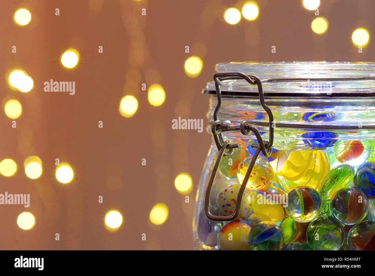 Jar of Marbles and Christmas festive lights Stock Photo